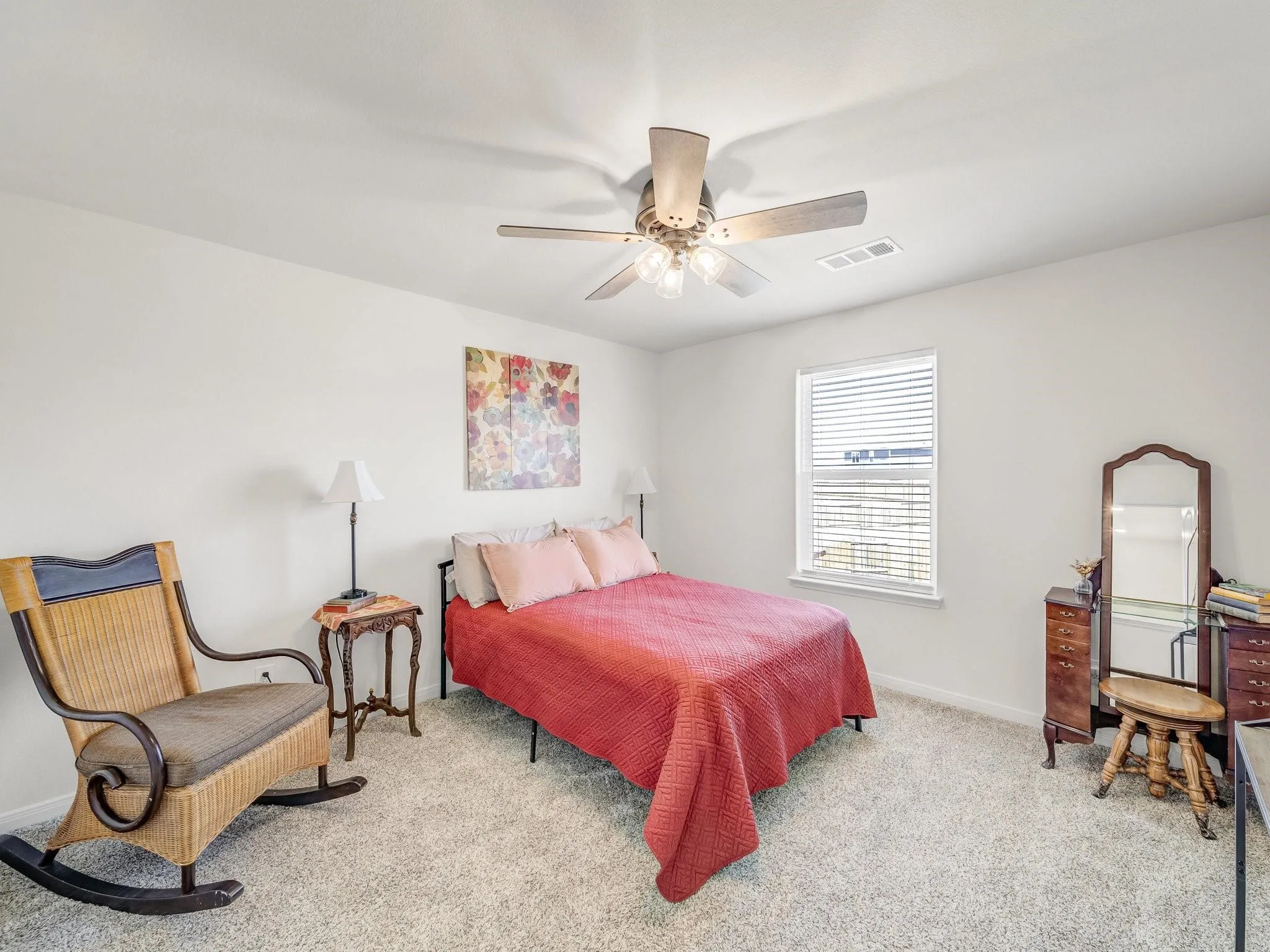 Carpeted room featuring a ceiling fan with integrated lighting, a window with blinds, and white walls