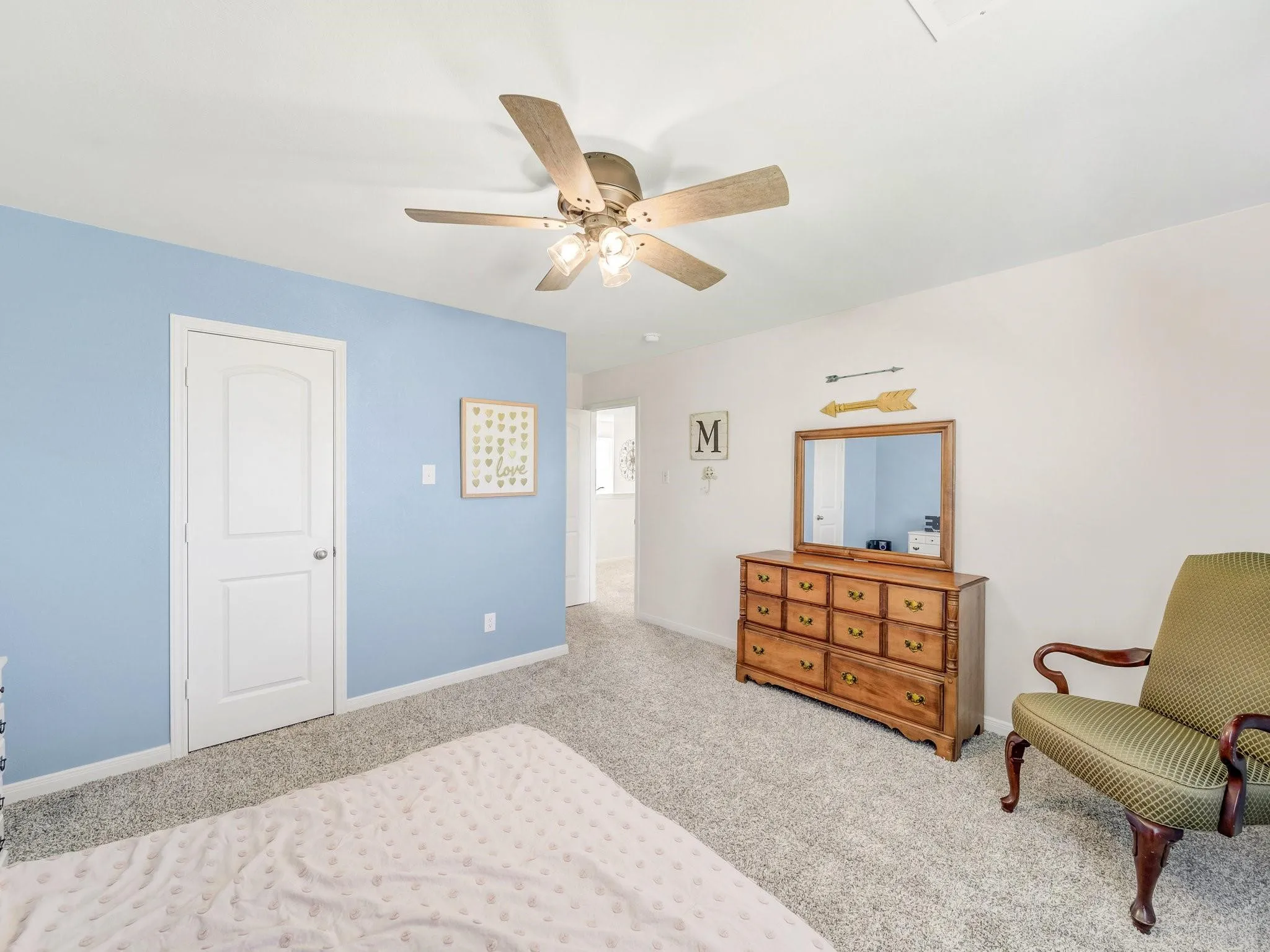 Plush carpet flooring complements pale blue and white wall tones