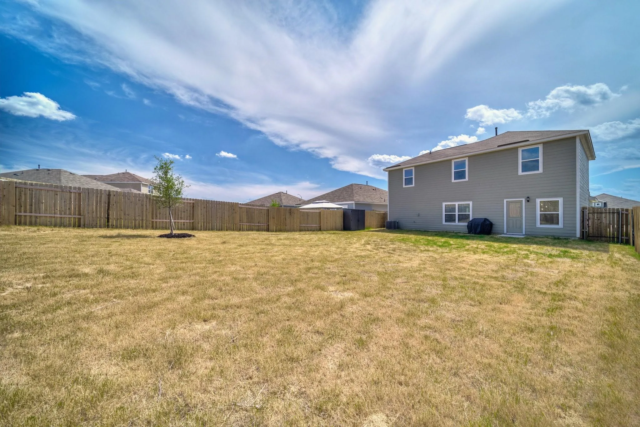Expansive backyard with a full privacy fence