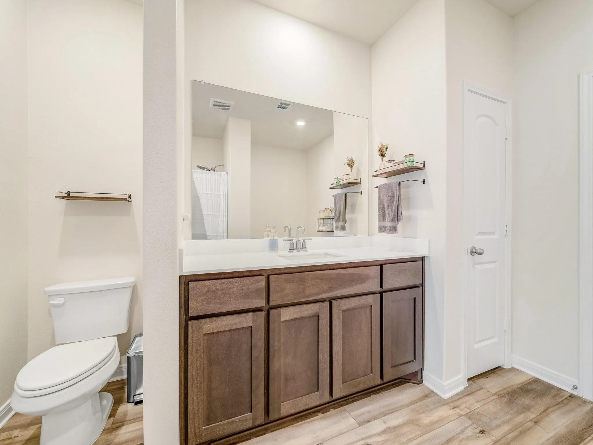 Vanity featuring a single sink, white countertop, and dark wood-finish cabinetry