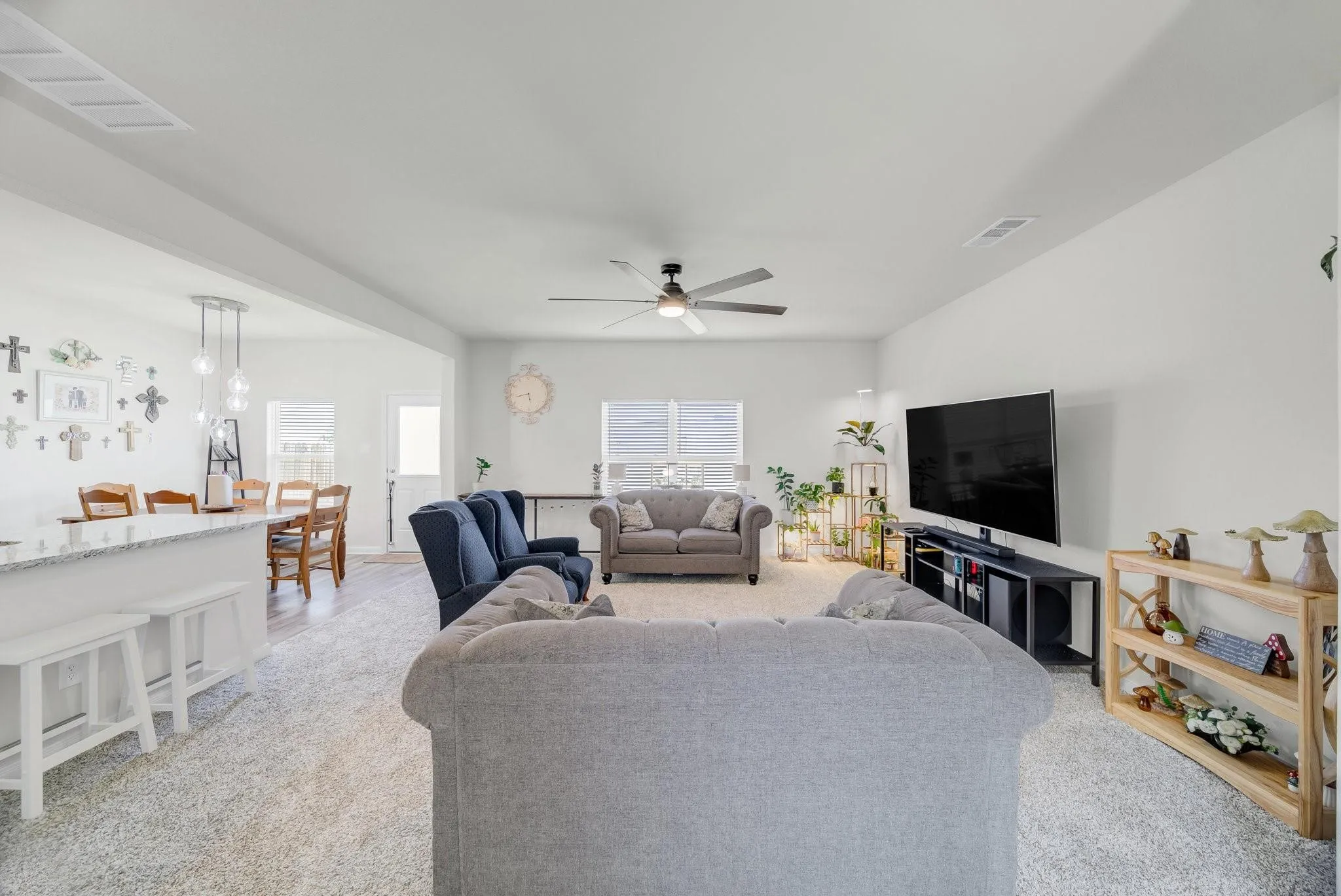 Open-concept living space featuring a spacious living room, dining area, and kitchen pass-through