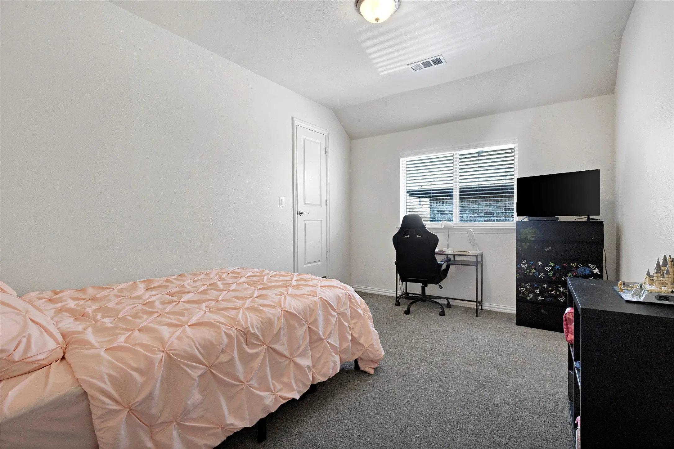 Neutral-toned wall paint and grey carpeting define this room