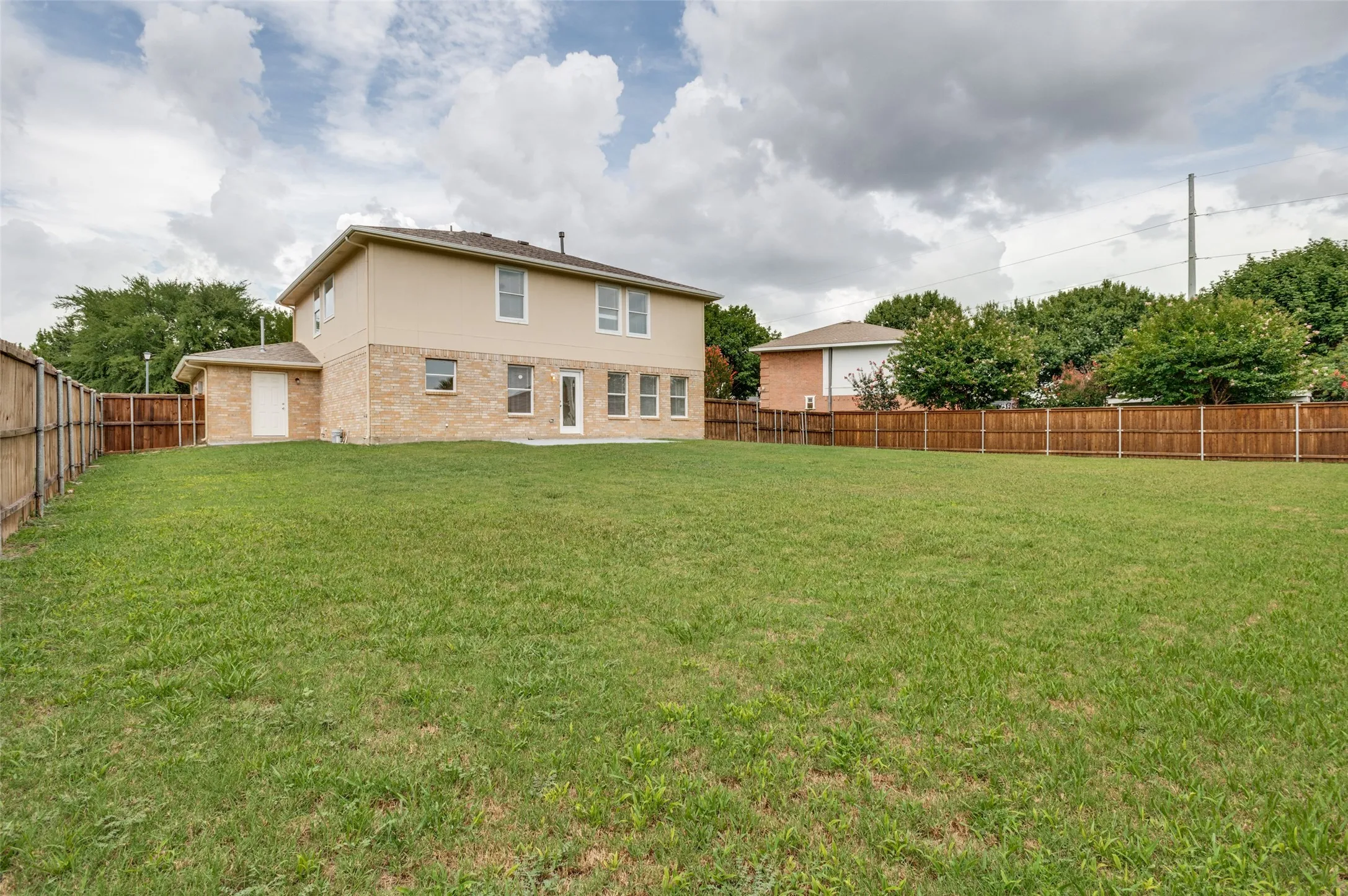 Large backyard with board on board wood fence