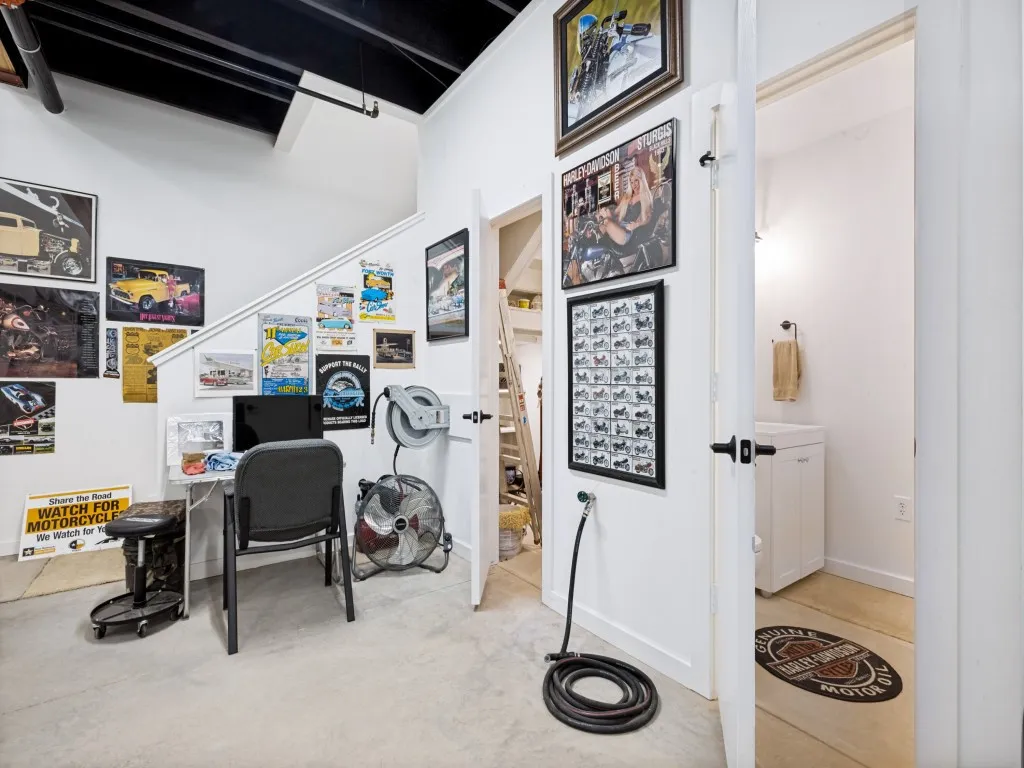 Versatile lower-level space featuring a concrete floor, painted white walls, and an exposed black ceiling