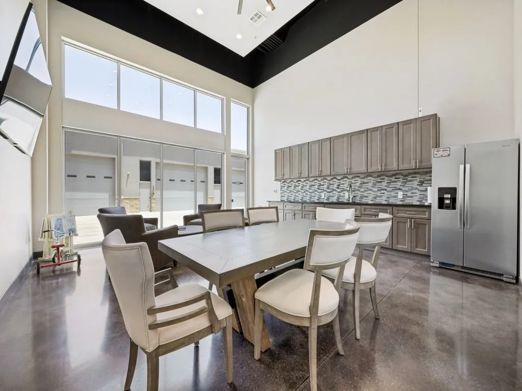 Spacious clubhouse featuring polished concrete flooring and soaring ceilings