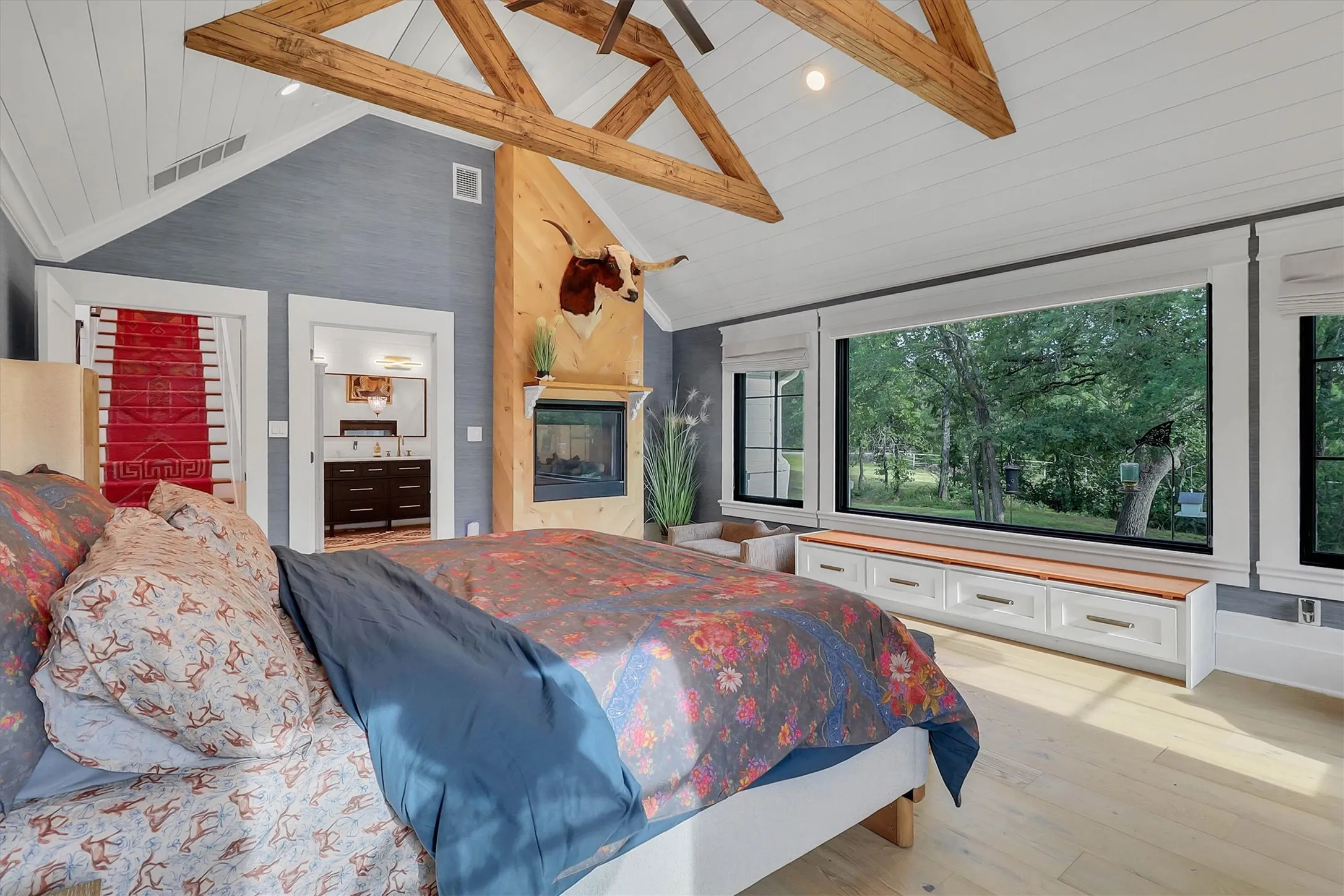 Vaulted shiplap ceiling with exposed wood beams