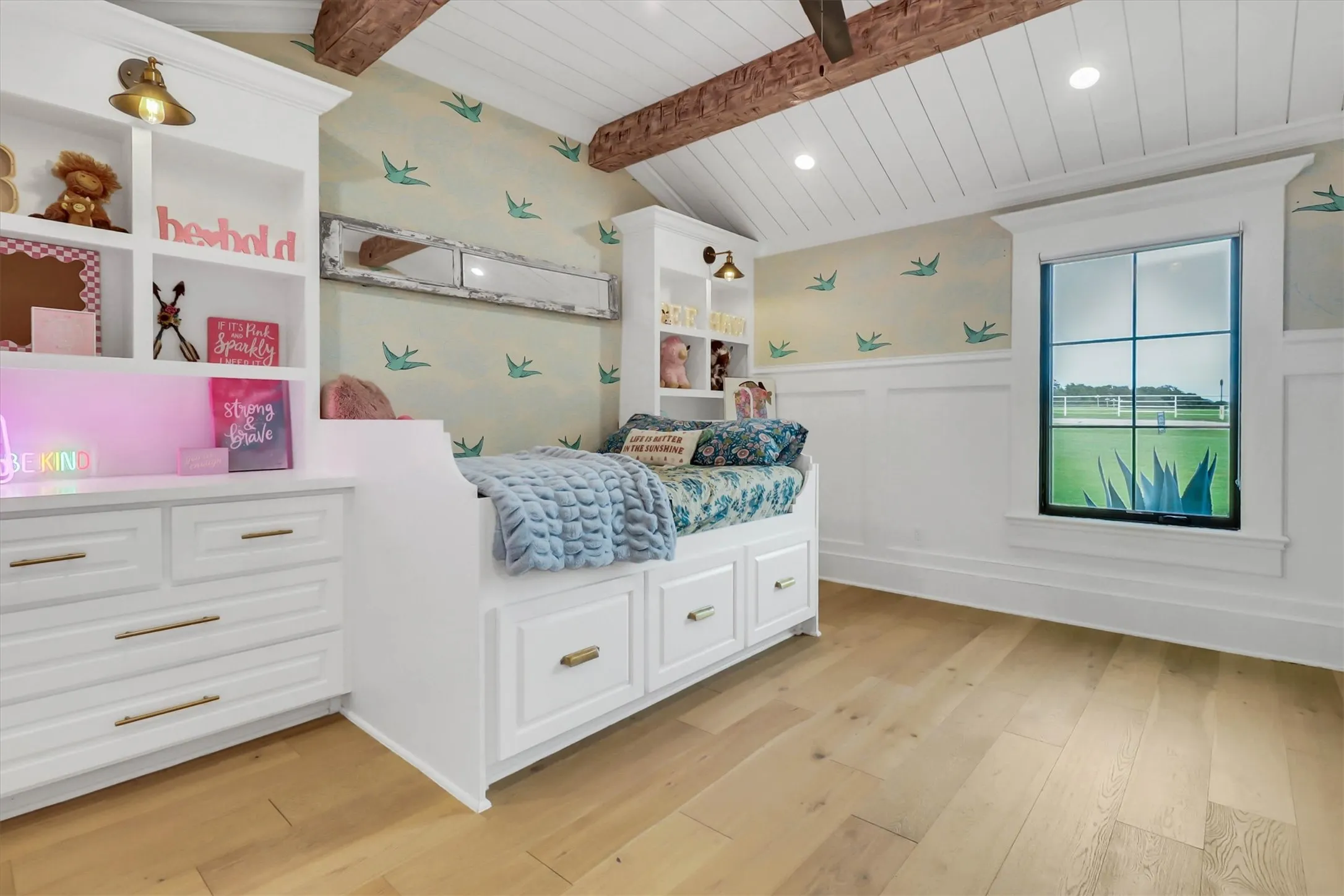 Vaulted ceiling with exposed wood beams and white shiplap finish