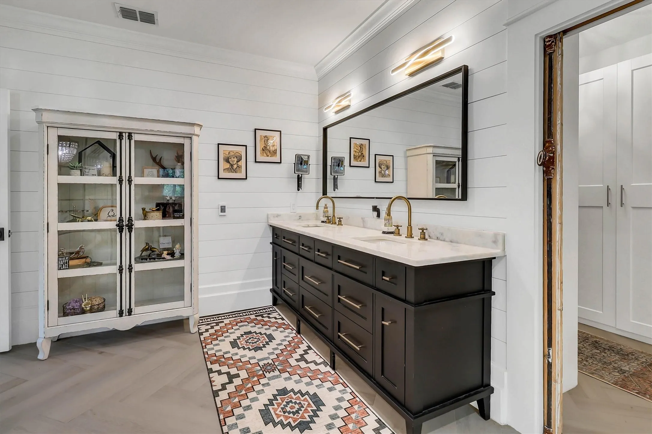 Dual vanity with black cabinetry and a white countertop
