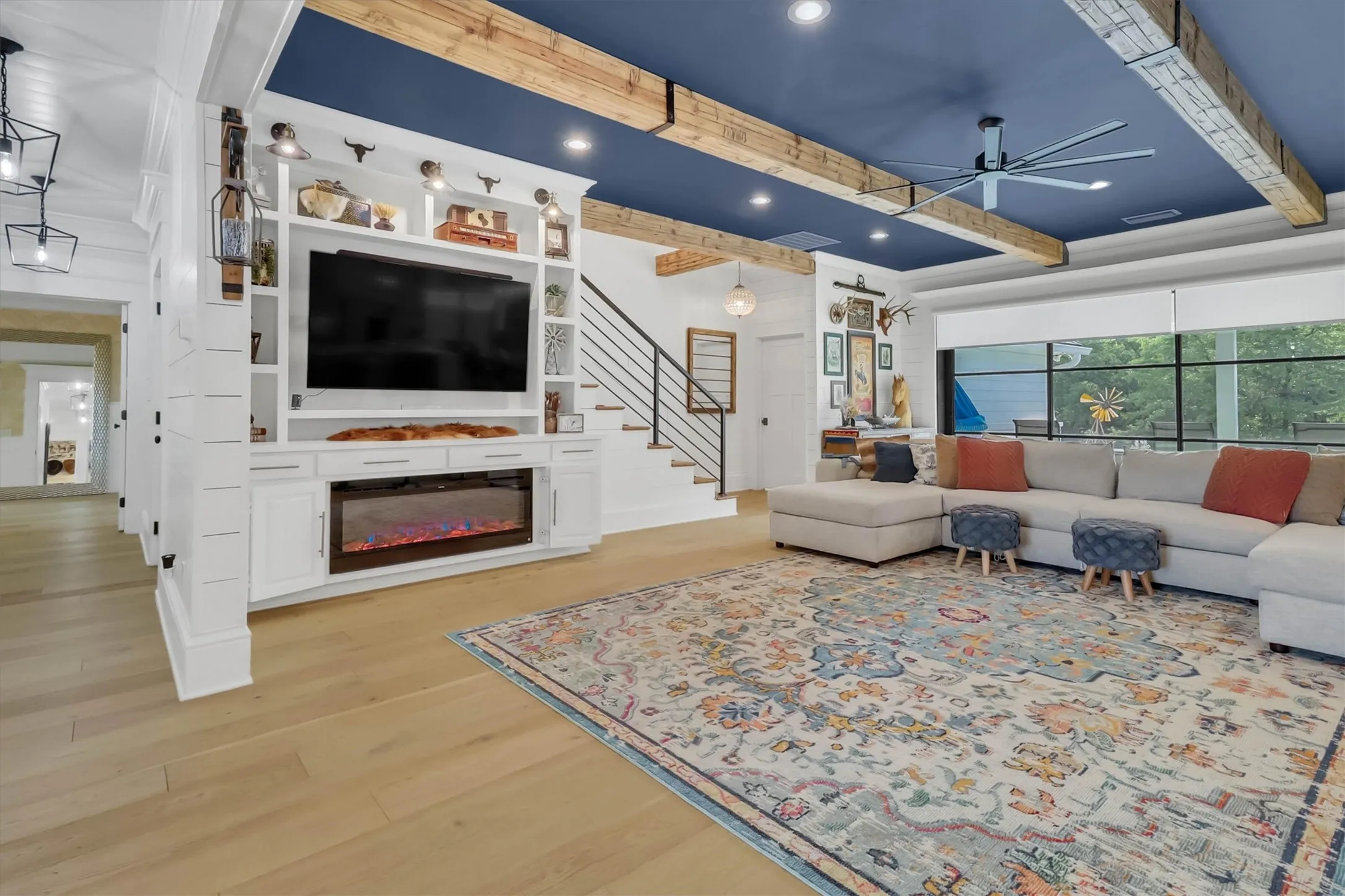 Living area featuring a floor-to-ceiling media center with built-in cabinetry and an electric fireplace