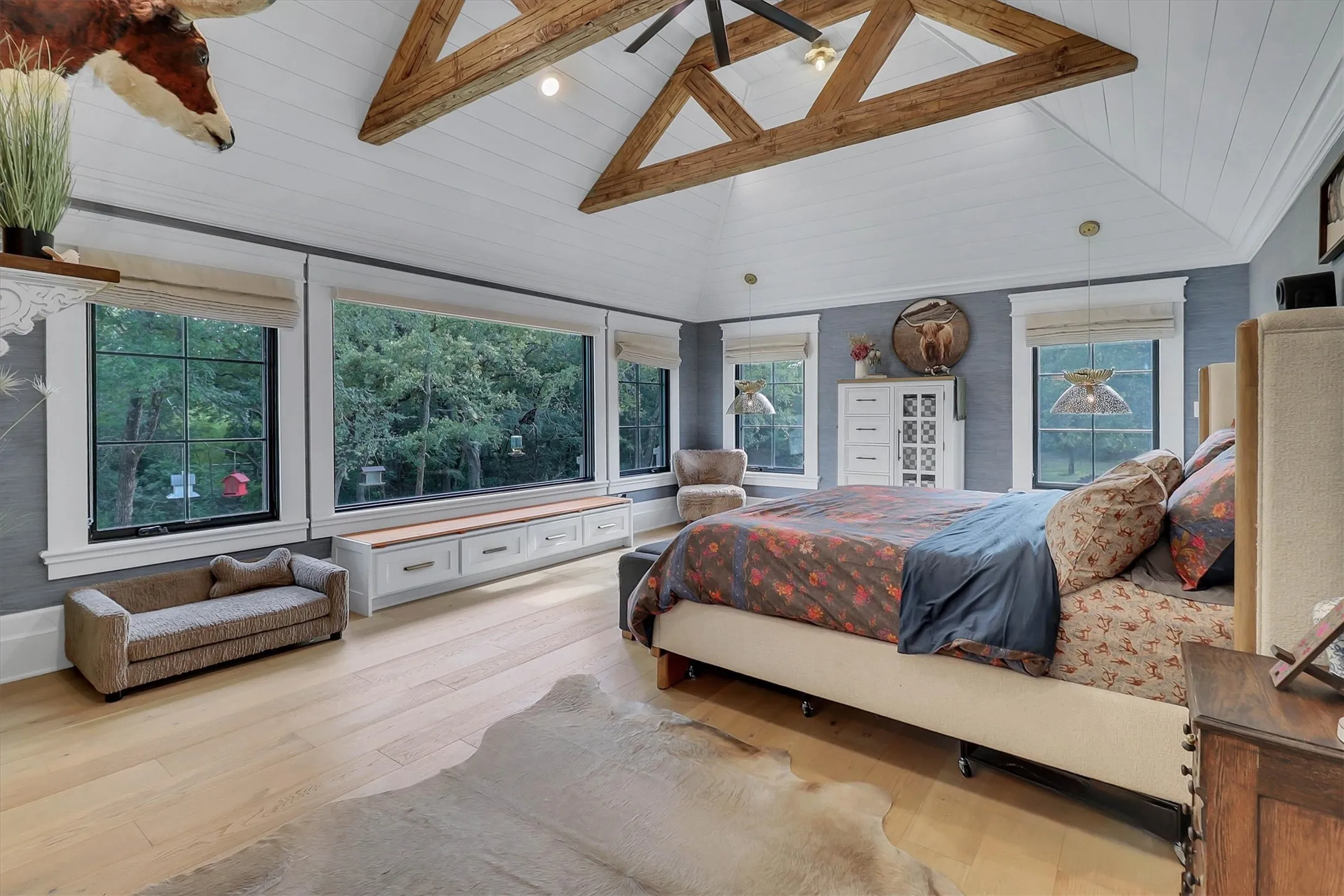 Vaulted ceiling featuring exposed wooden beams and a ceiling fan