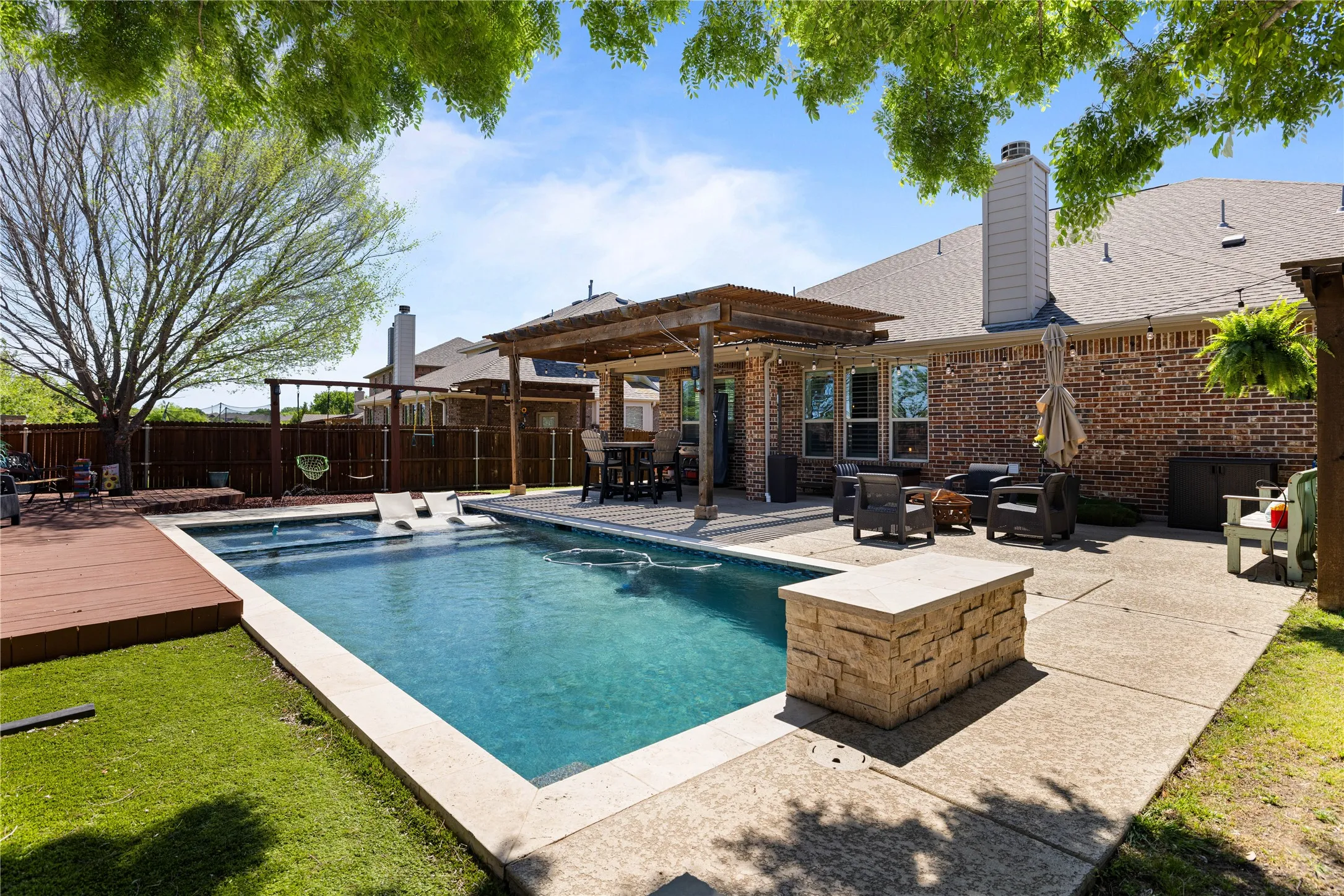 View of swimming pool with a deck and a pergola
