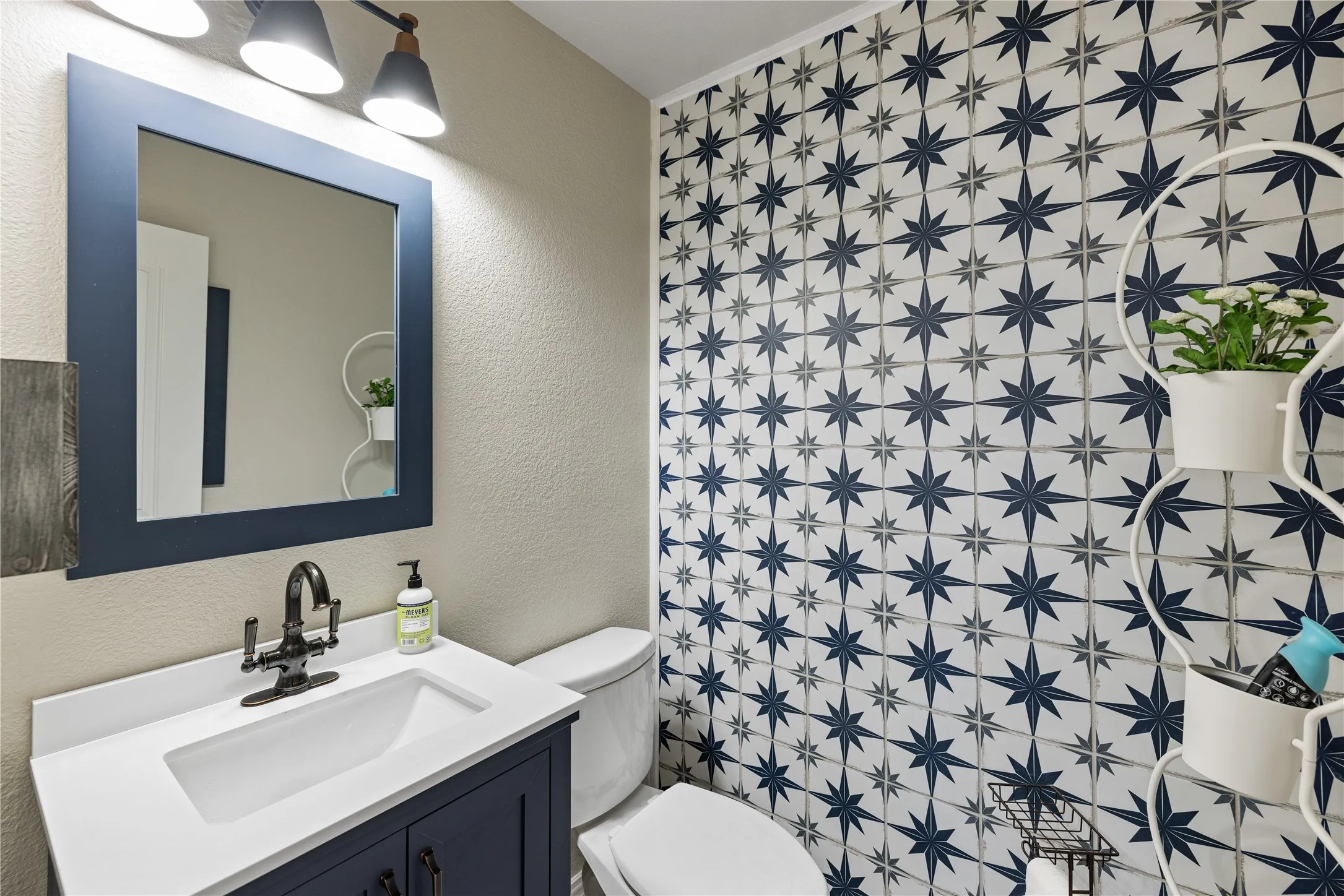 Bathroom featuring oversized vanity, toilet, and tile flooring