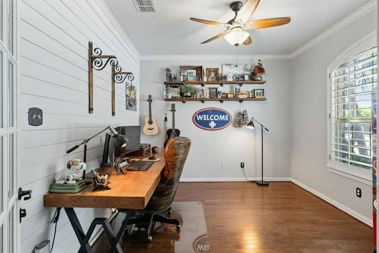 Dedicated workspace featuring a shiplap accent wall and wood-finish flooring
