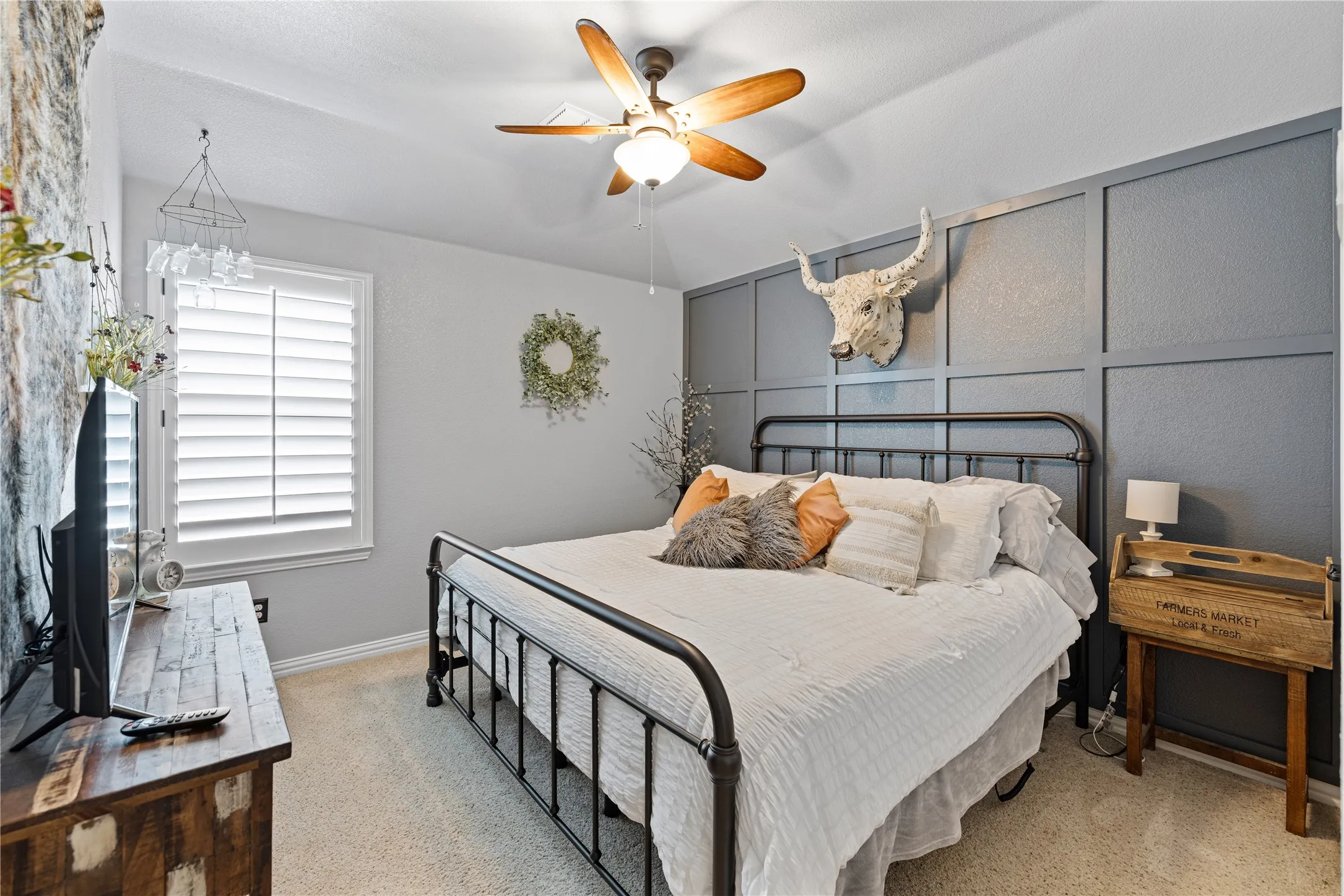 Carpeted bedroom with ceiling fan