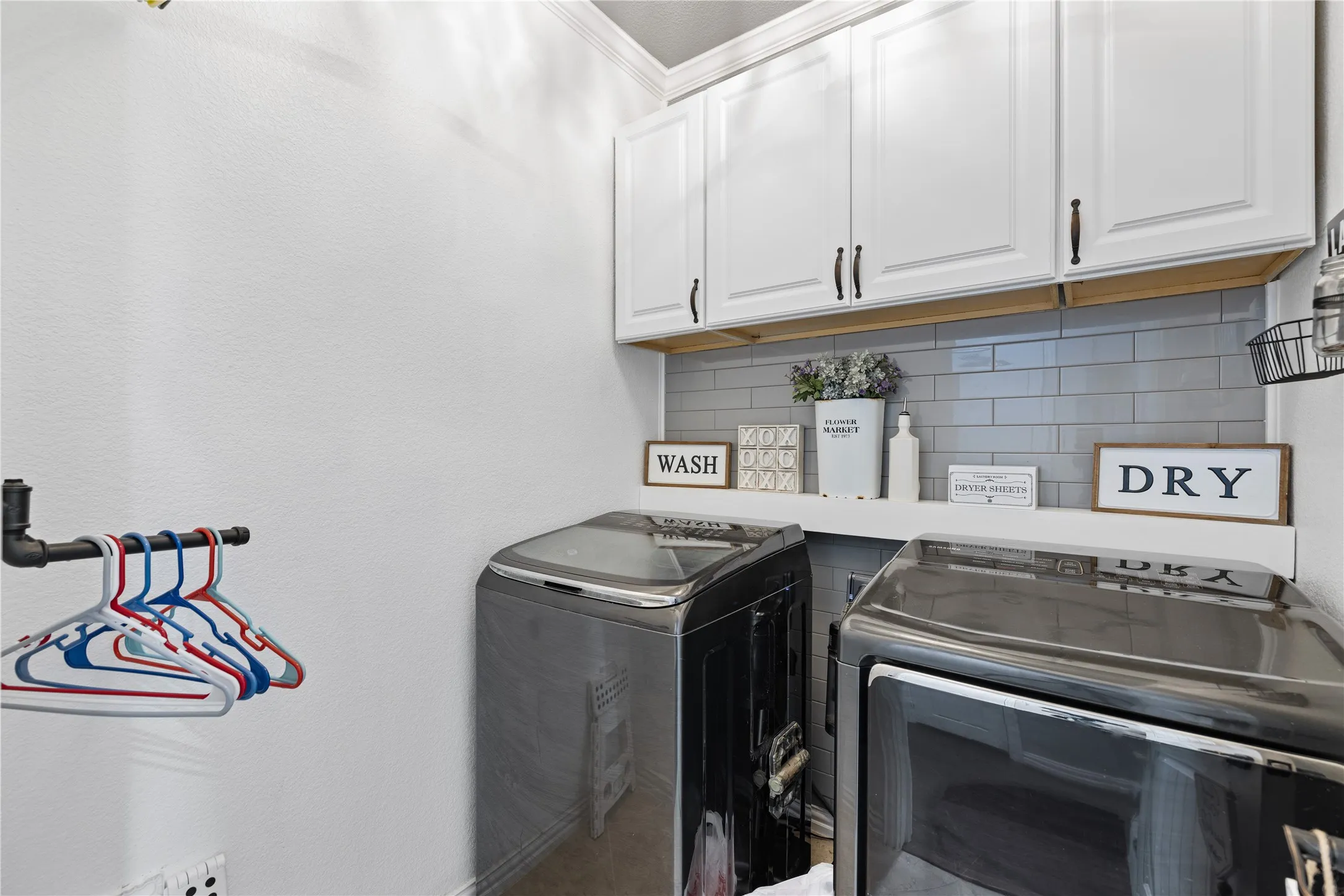 Laundry room with cabinets and washer and clothes dryer