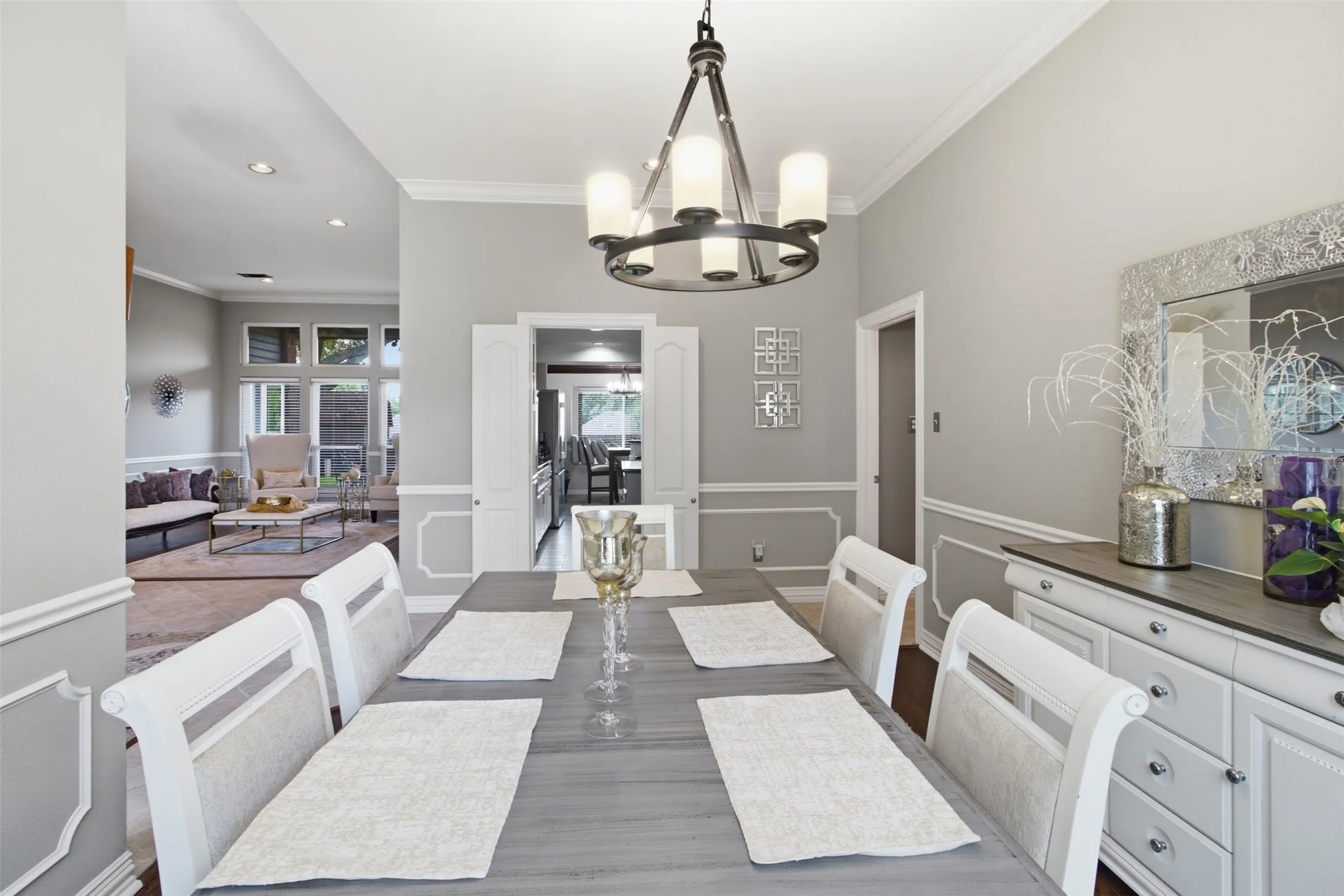 Formal dining area featuring crown molding, wainscoting, and wood-finish flooring