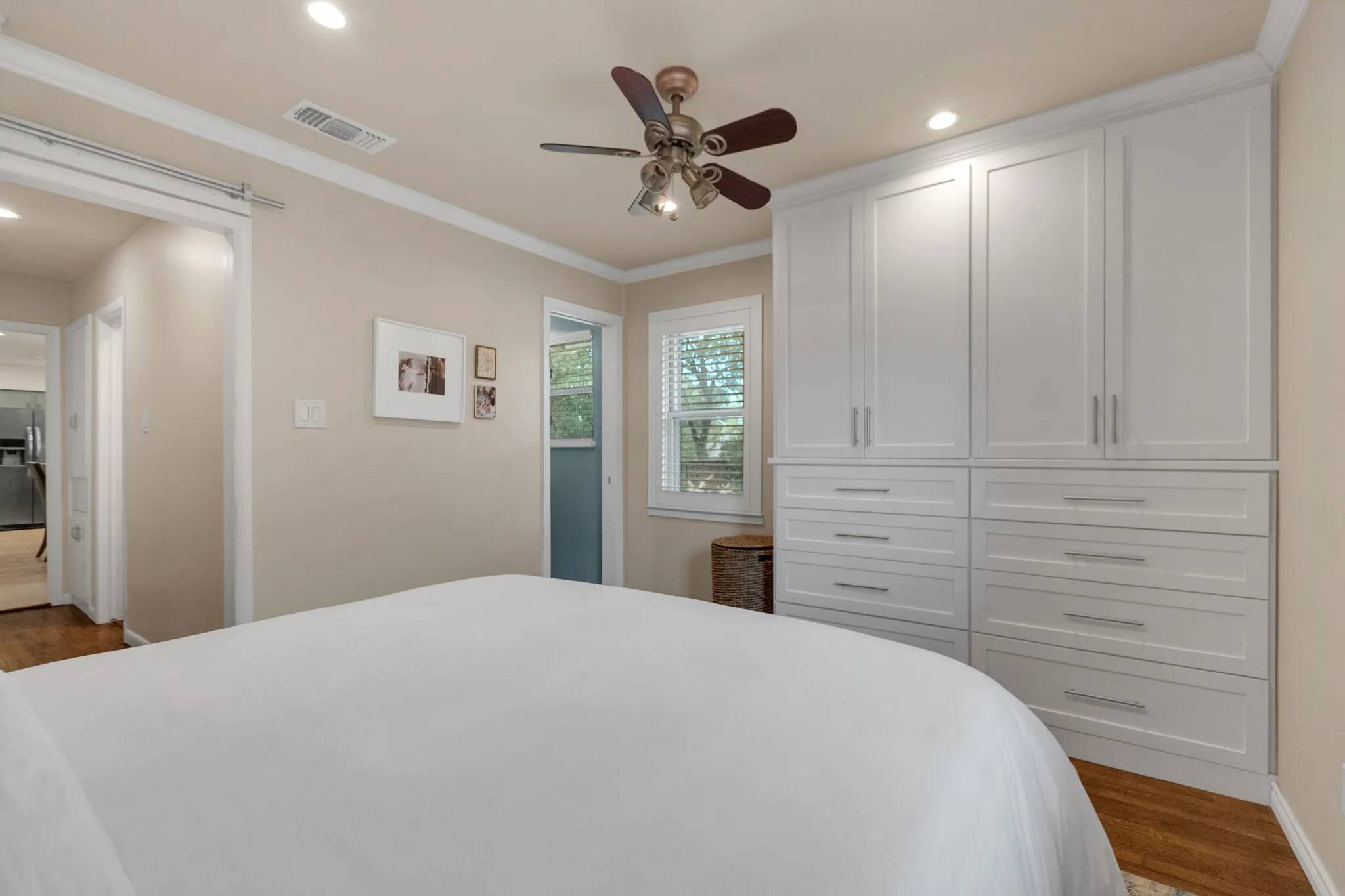 Integrated white cabinetry with ample storage, featuring both upper cabinets and lower drawers