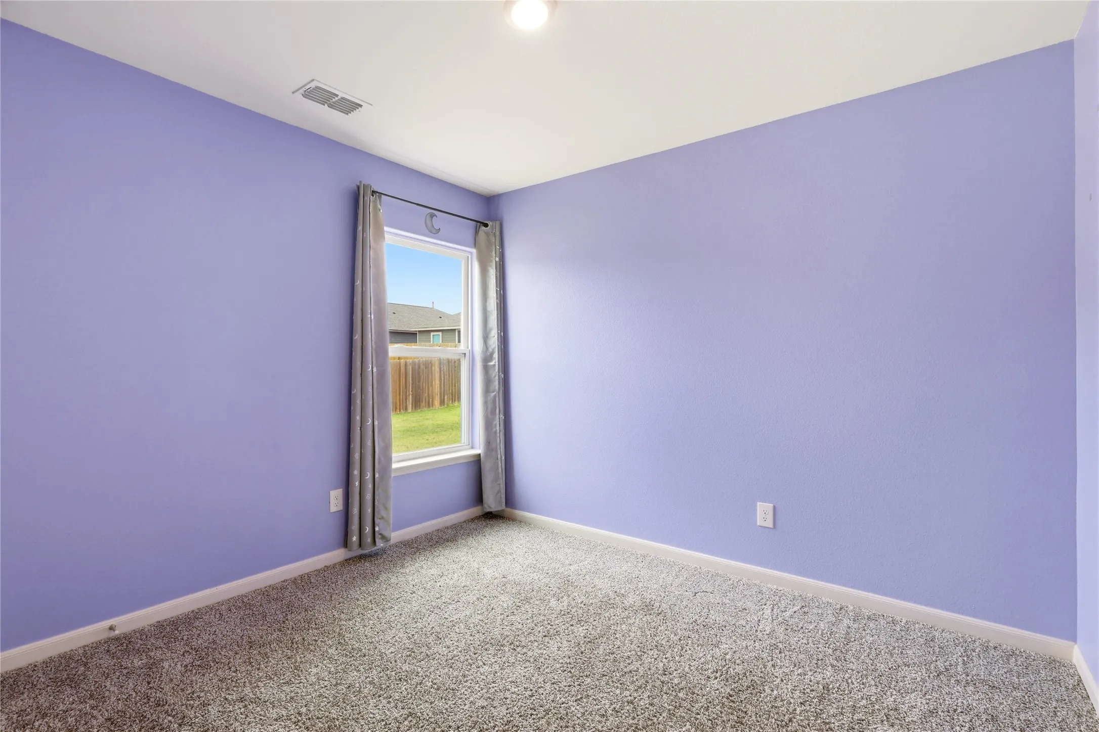 Second Bedroom with a window out to the side.