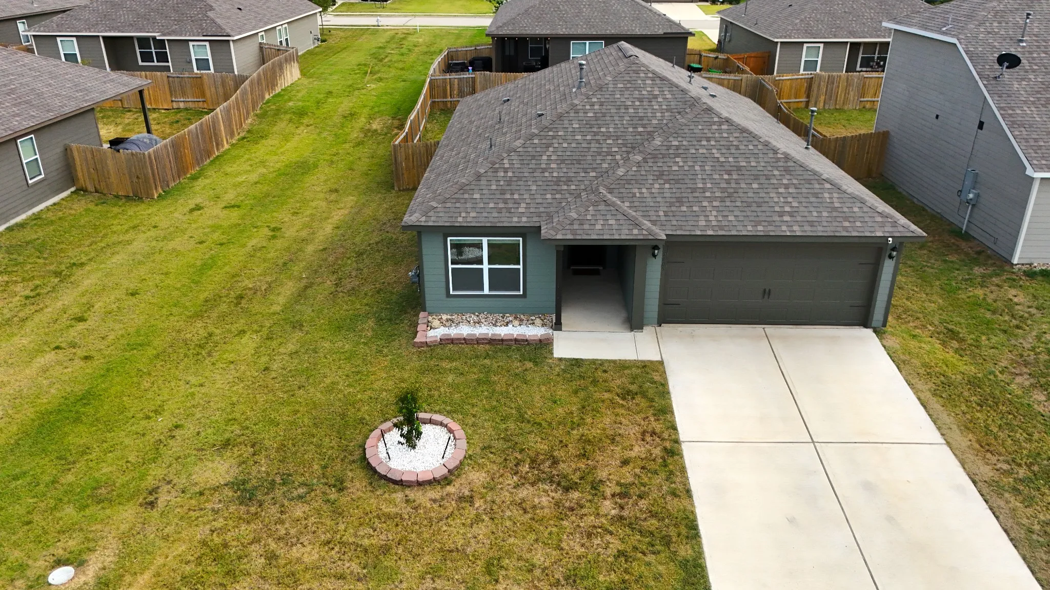 Aerial shot of the home's front, with space to the side.