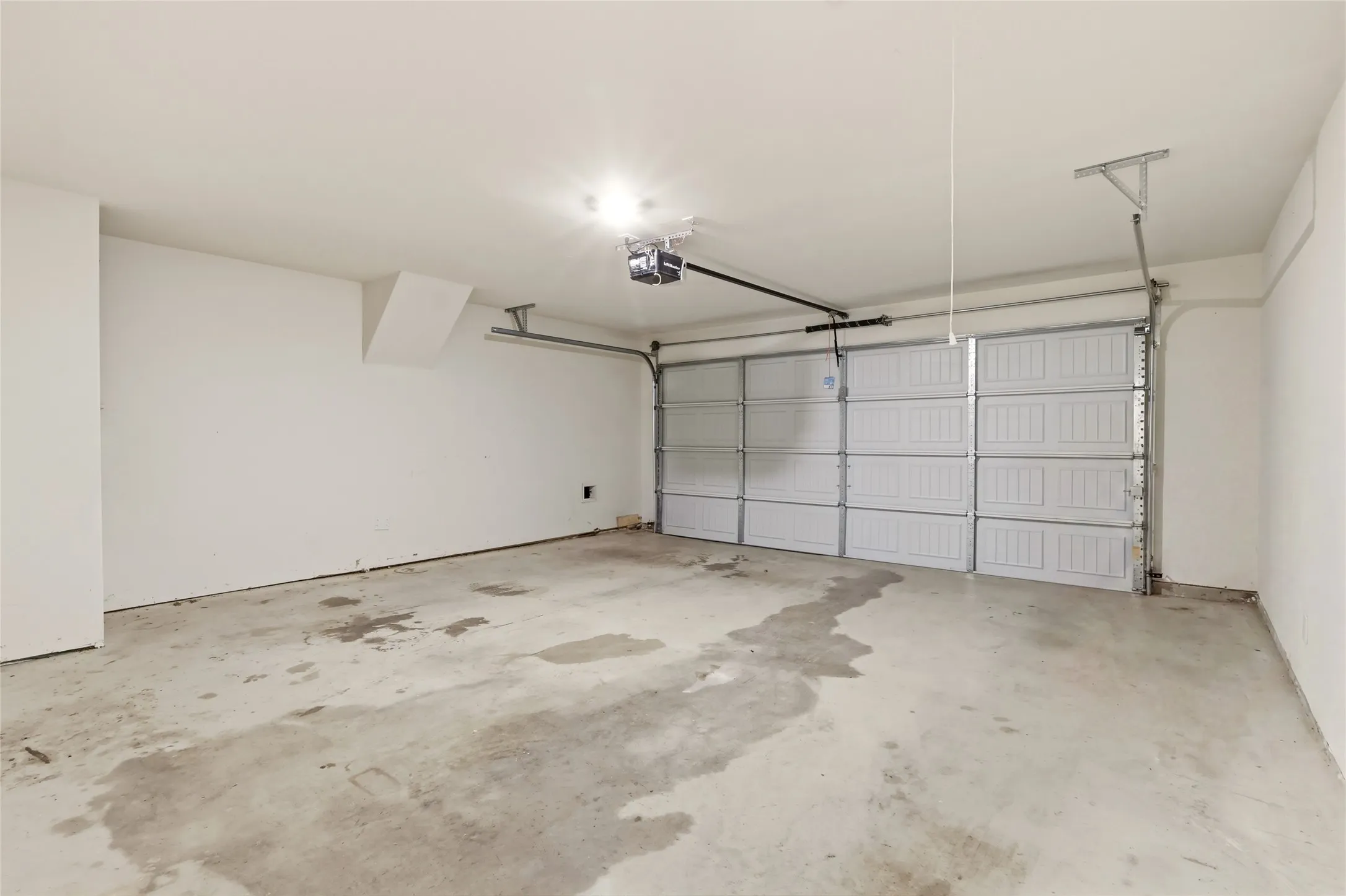Two-car garage with water heater.