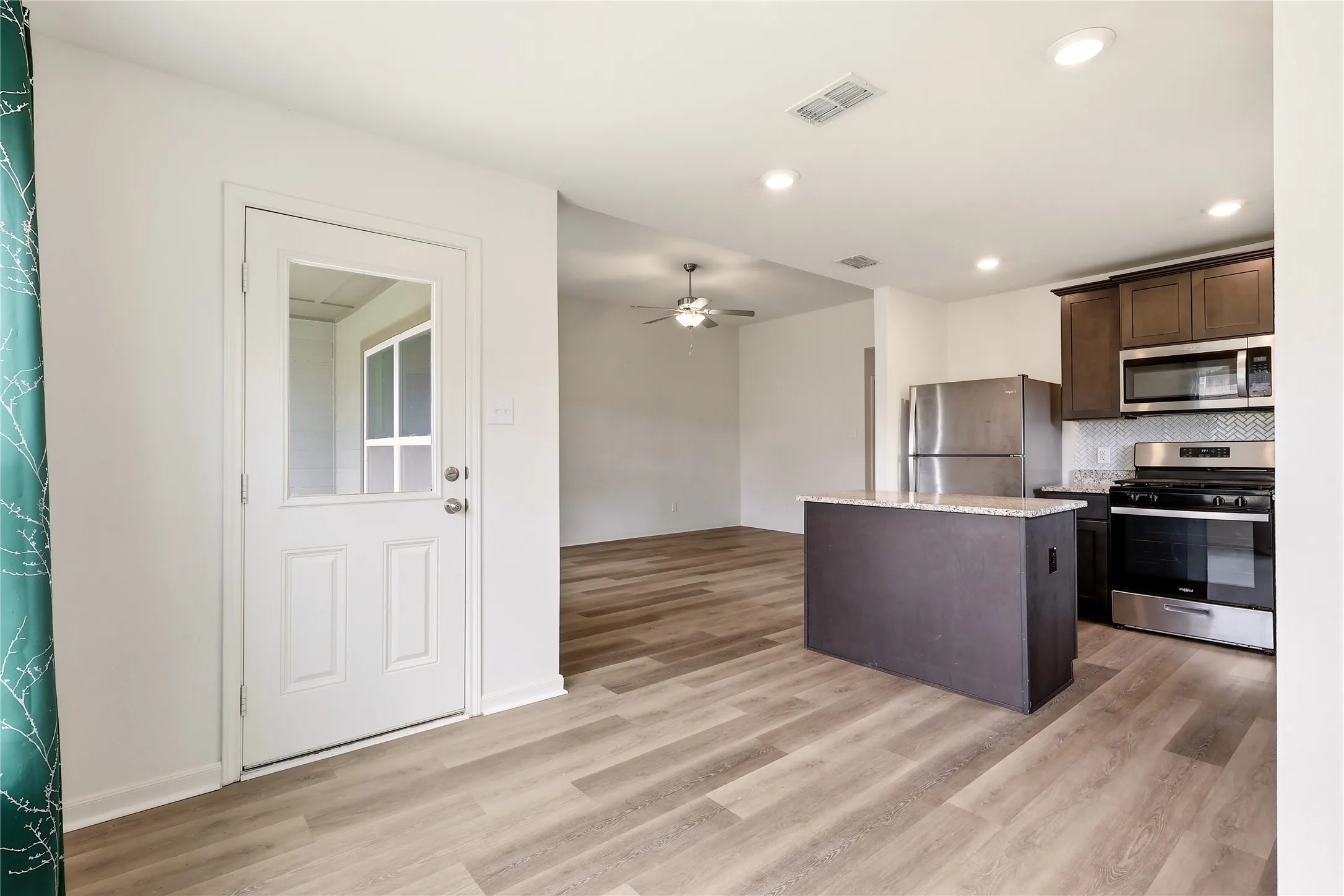 Dining space looking toward the kitchen and main living space.  Door to the covered patio.