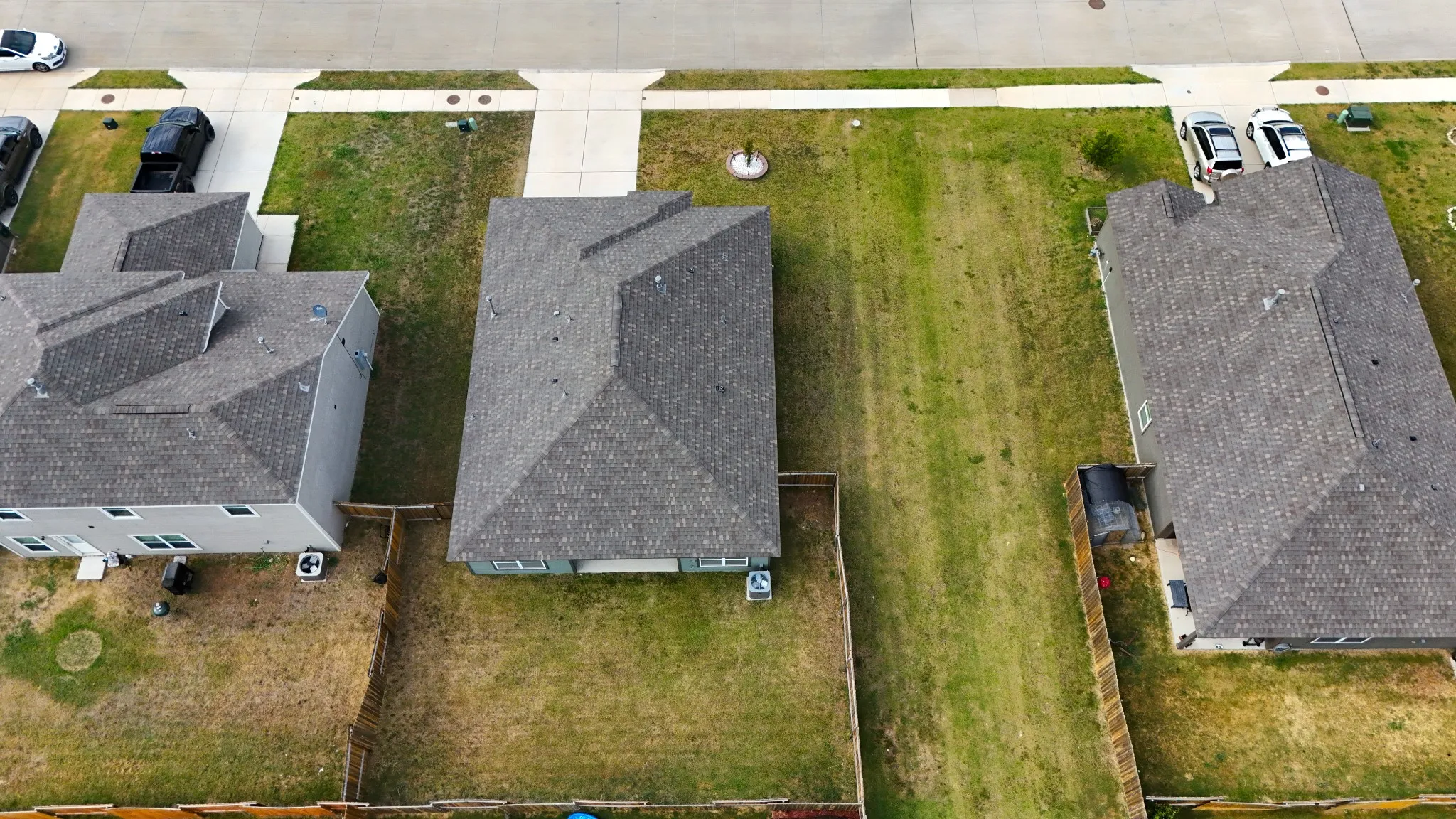 Aerial perspective showcasing the home's backyard and space to the side between homes.