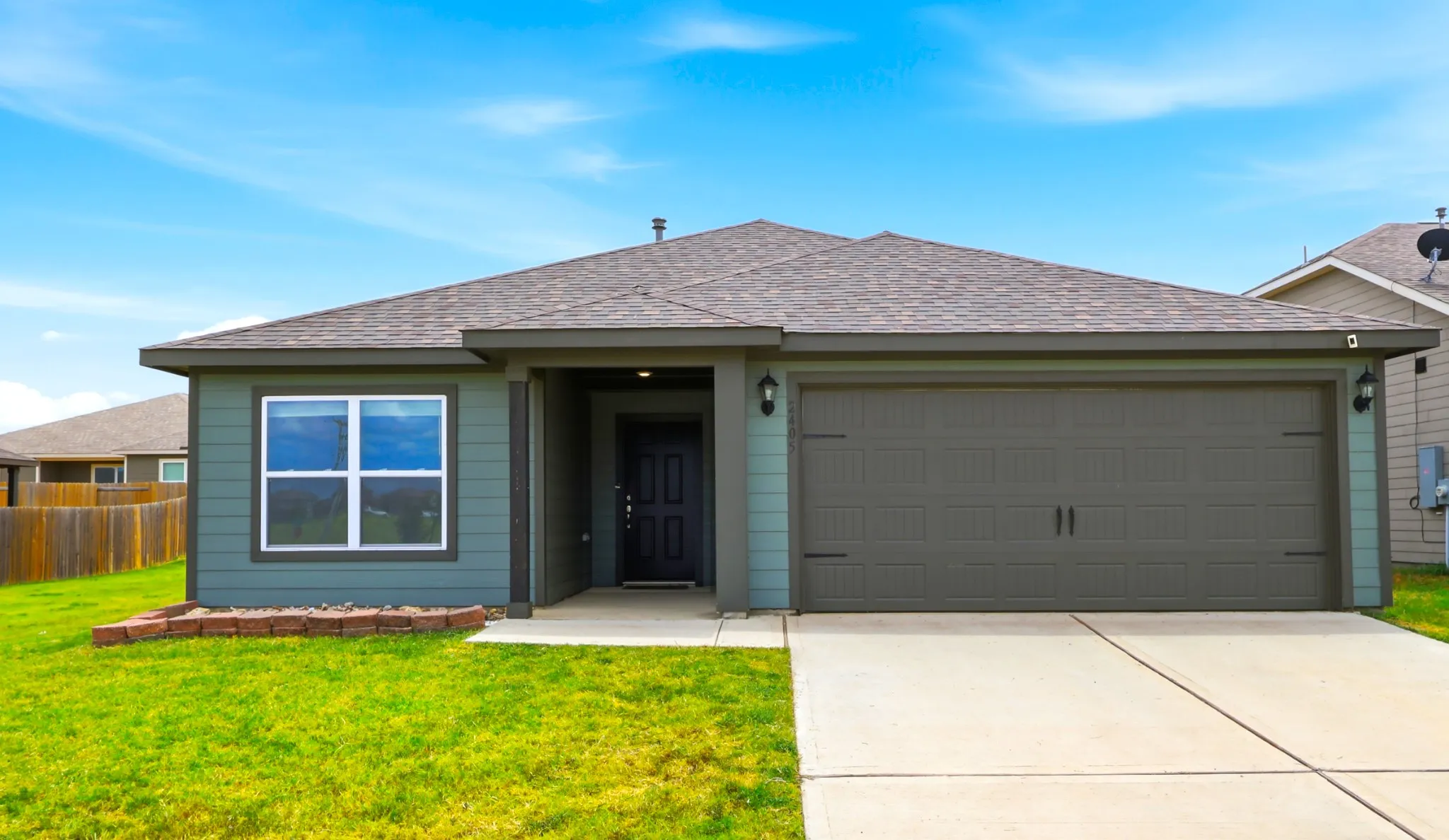 Front of home.  Front-facing two-car garage.