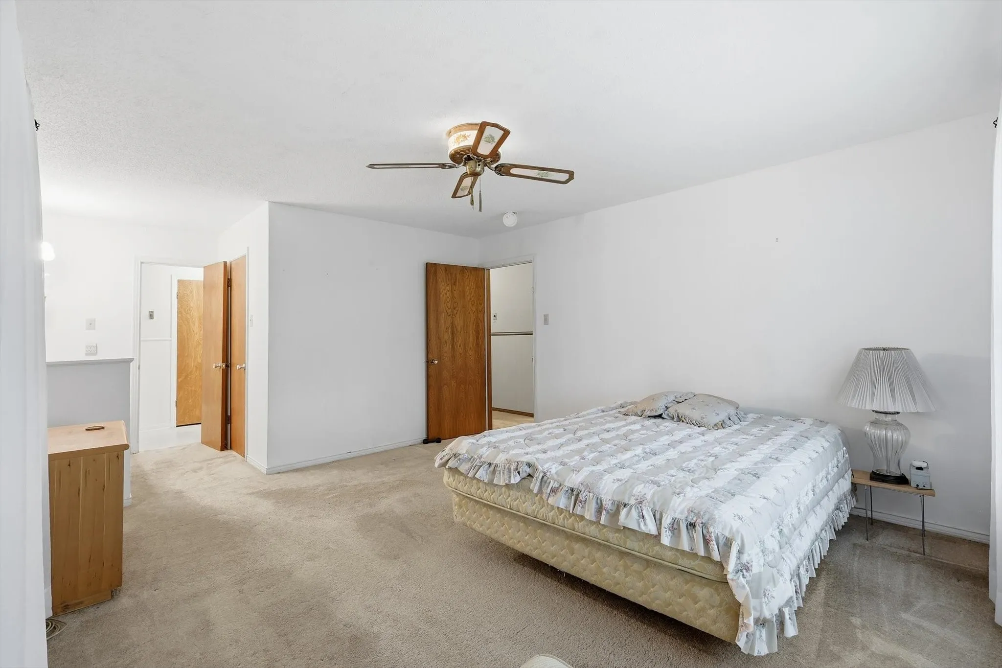 Spacious room featuring neutral carpeting and white walls