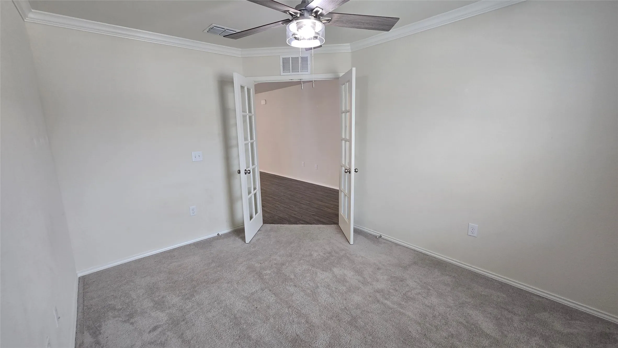Interior space featuring soft grey carpeting and light-colored walls