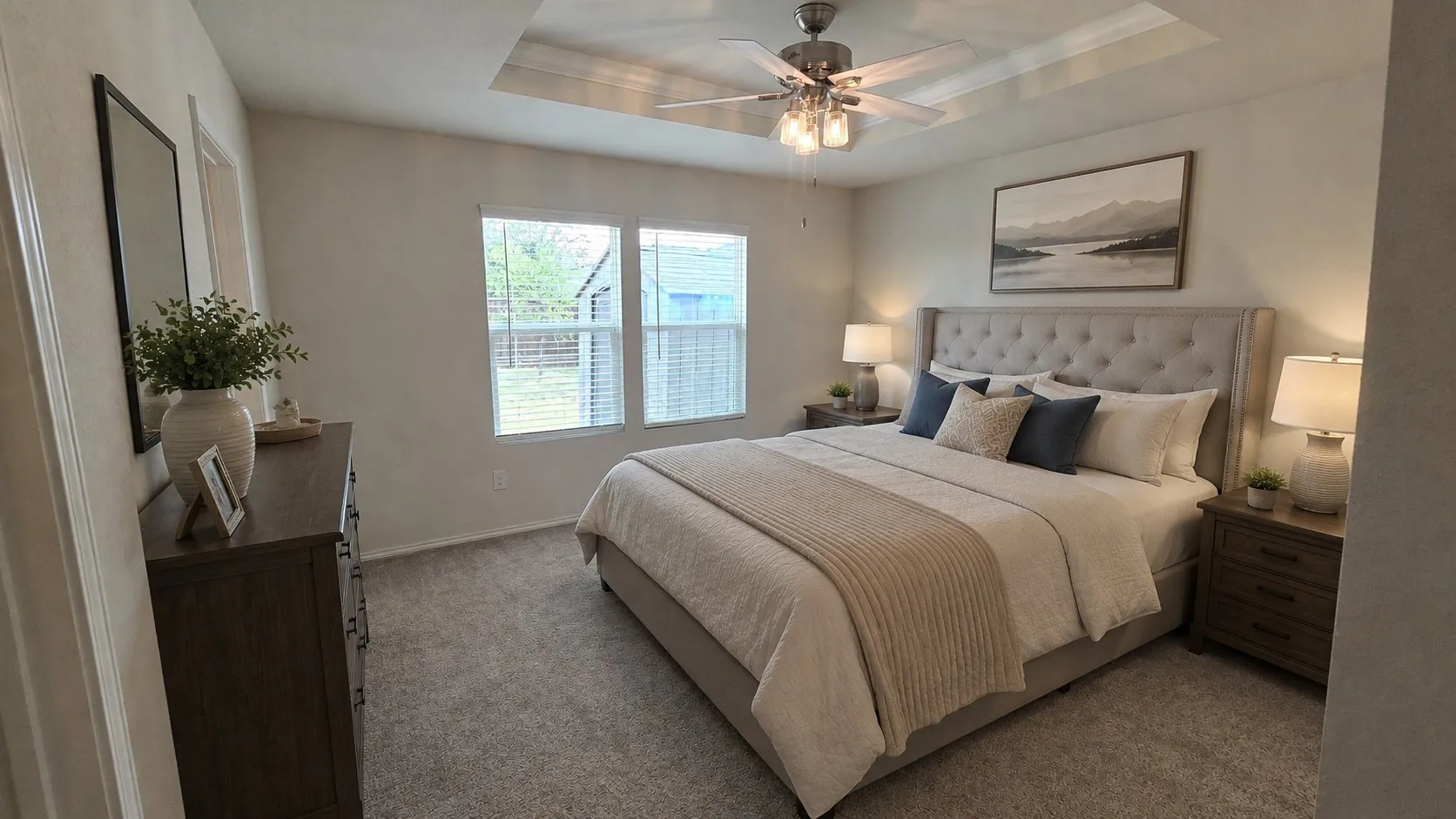 Virtual furnishings. Carpeted room featuring a tray ceiling with a ceiling fan, dual windows with blinds, and light-colored walls
