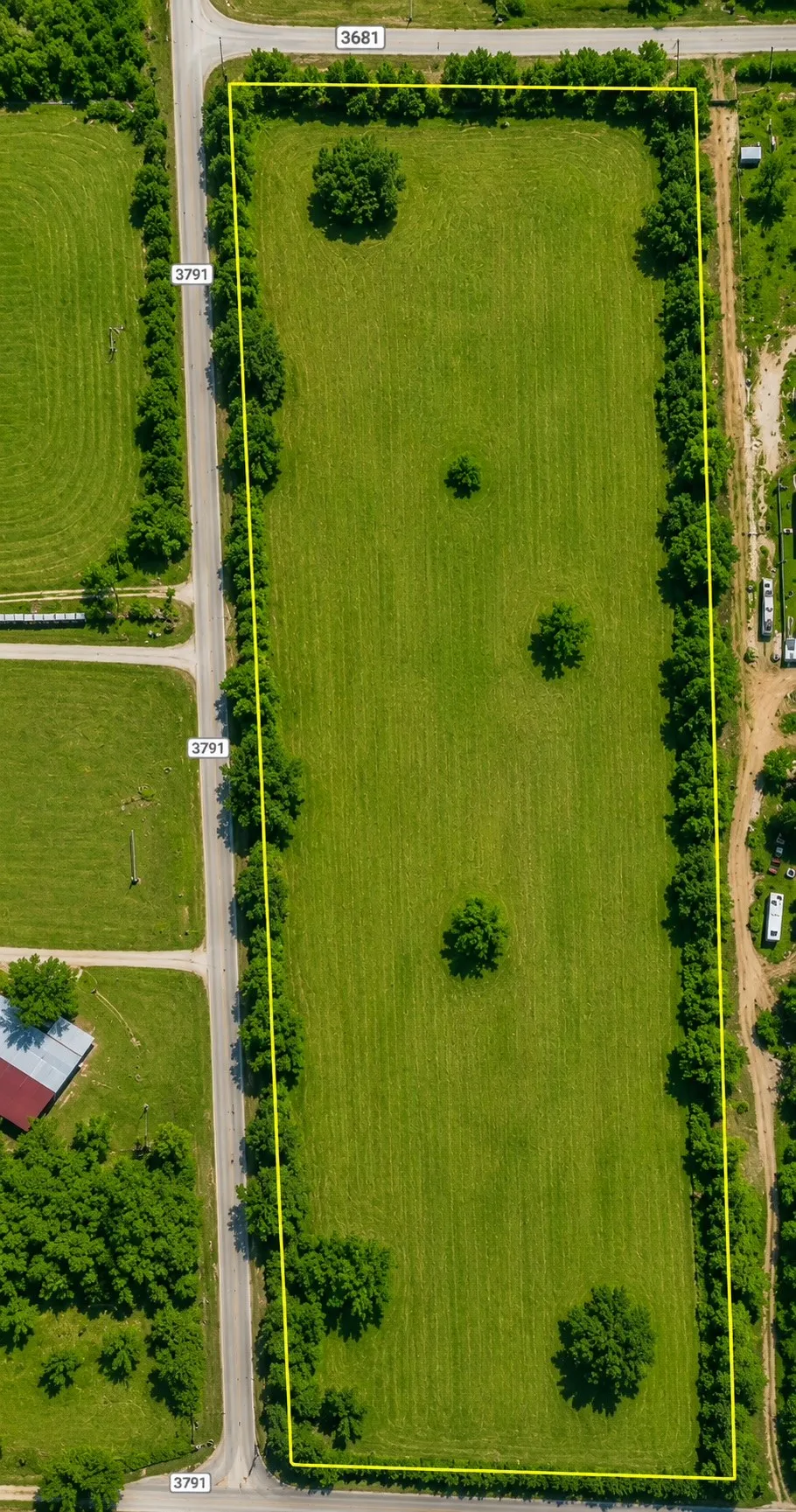 Expansive green acreage featuring mature trees and clear boundary lines