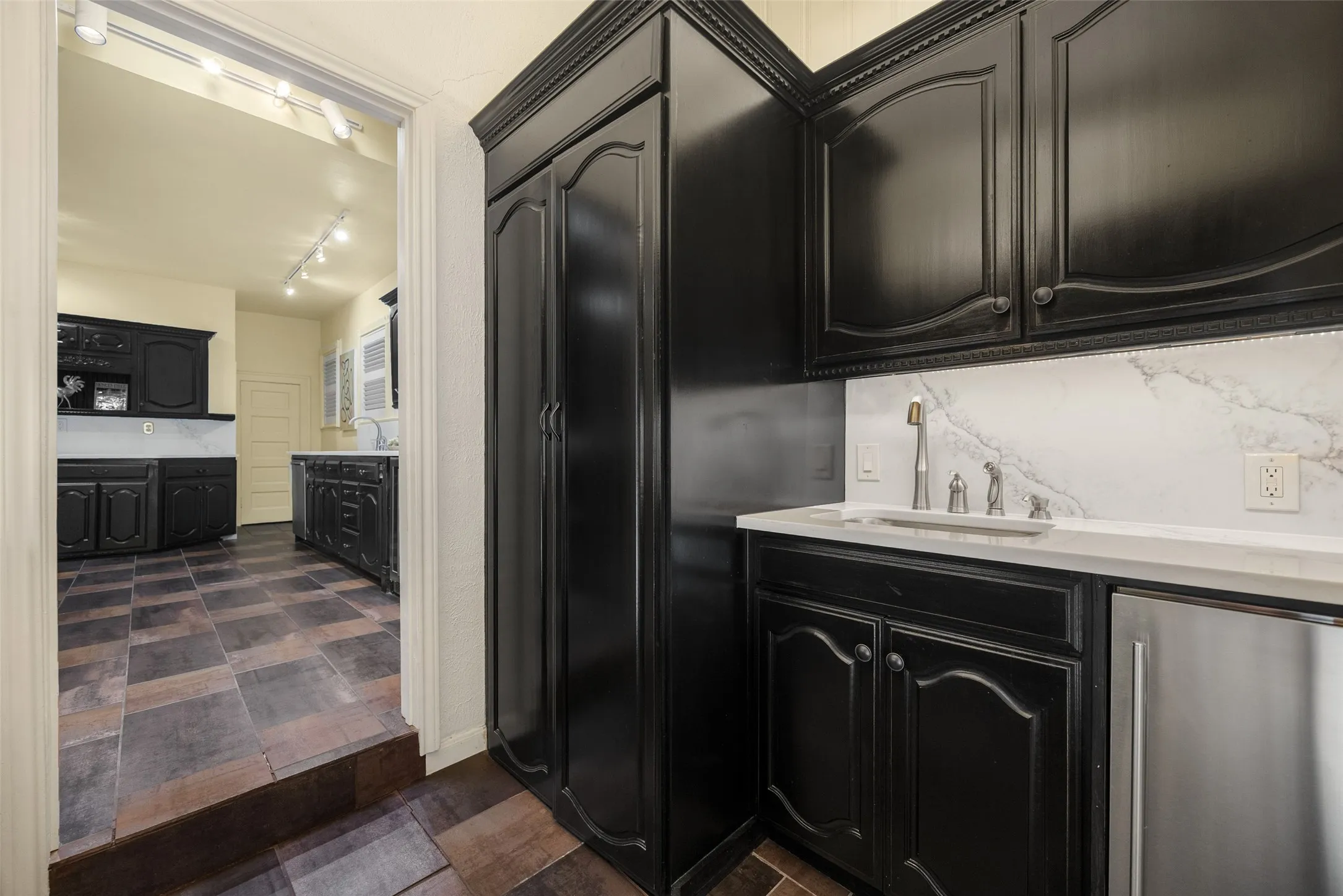 Attached Utility and Catering Kitchen Opens to Outdoor Kitchen