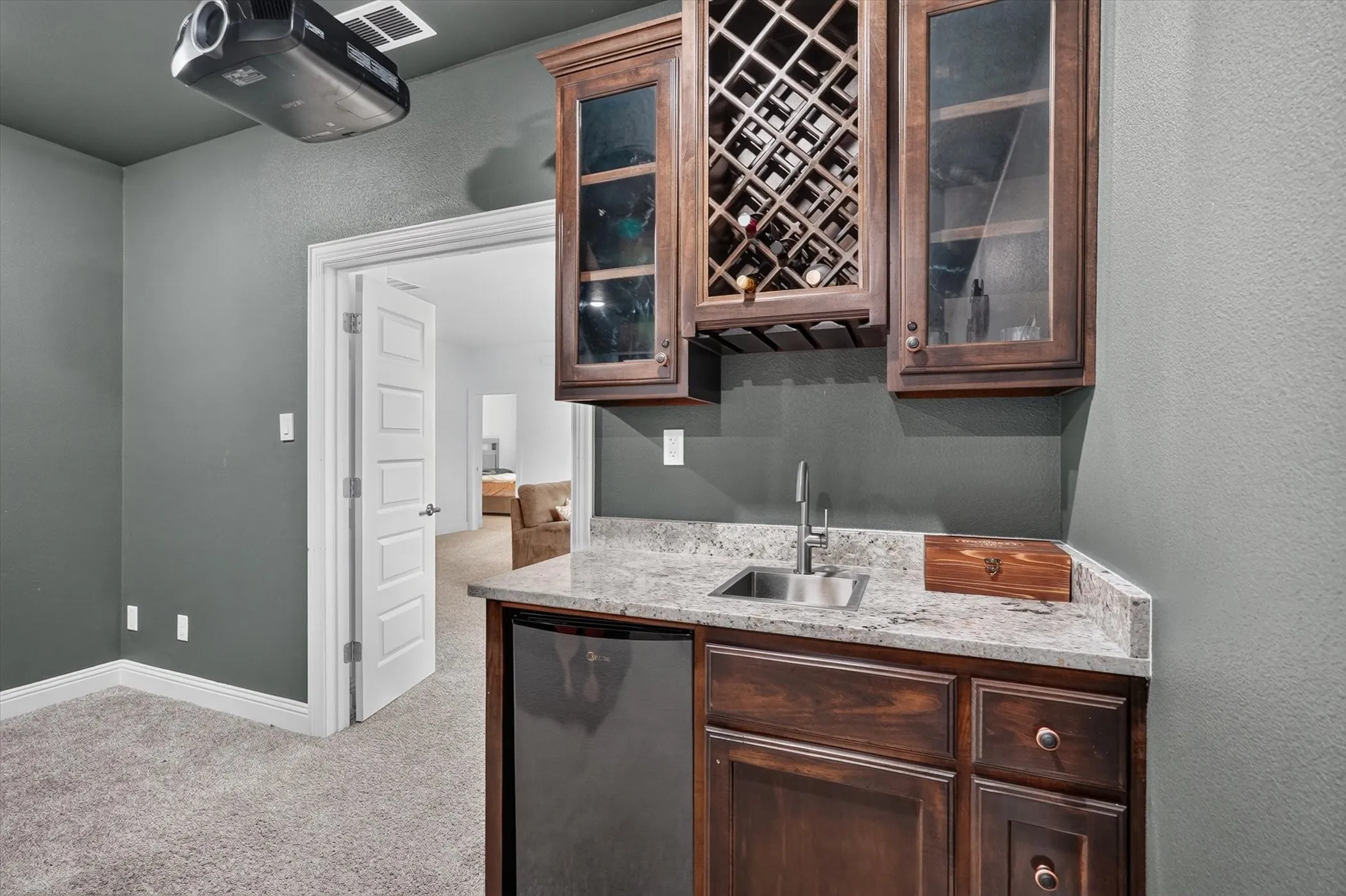 media room wet bar with beverage fridge