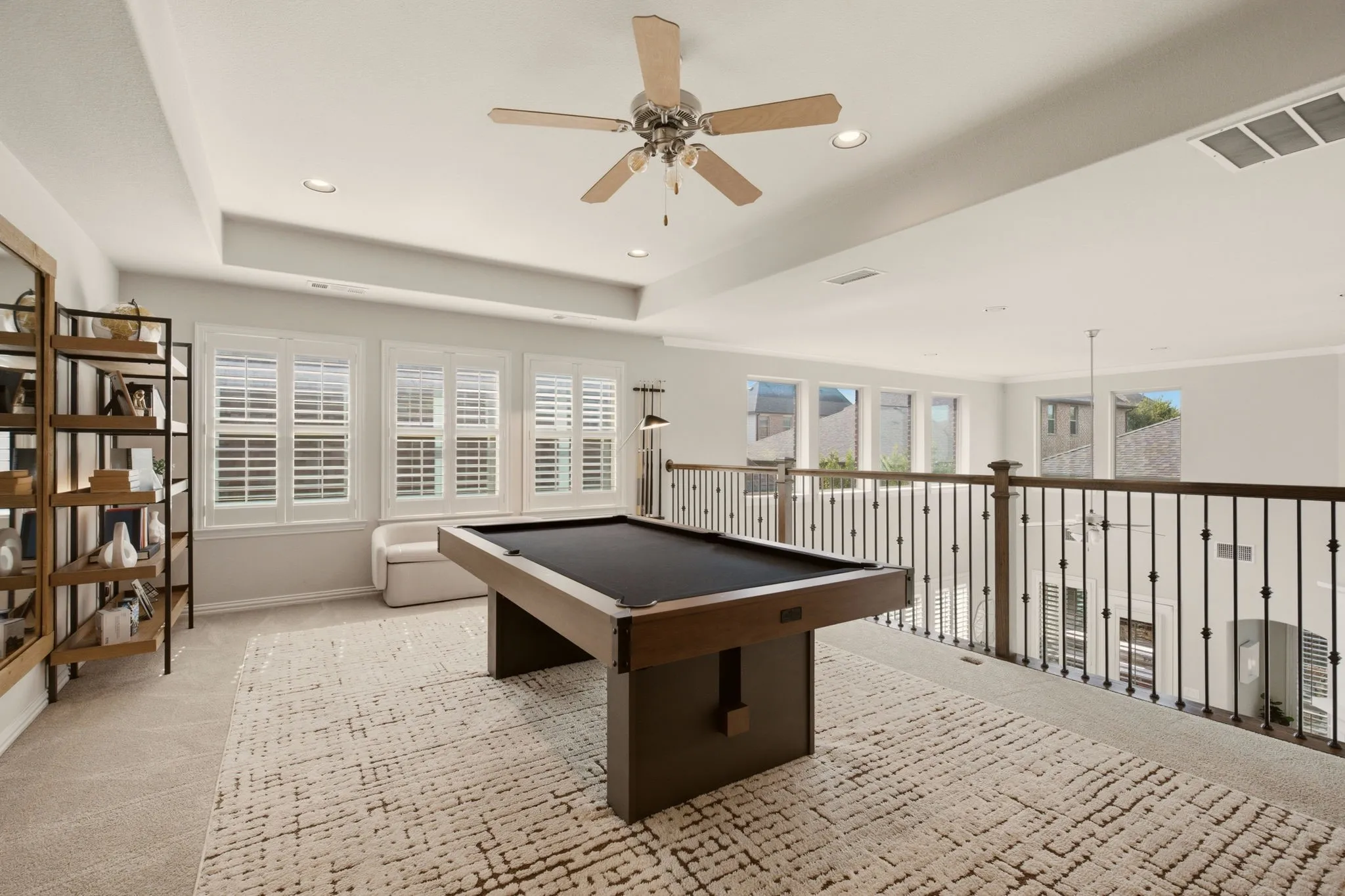 Walk upstairs to this large game room designed for family fun & easy entertaining. Filled with natural light from the wall of windows, the space feels open & inviting while still maintaining a cozy, tucked-away feel above the main living area.