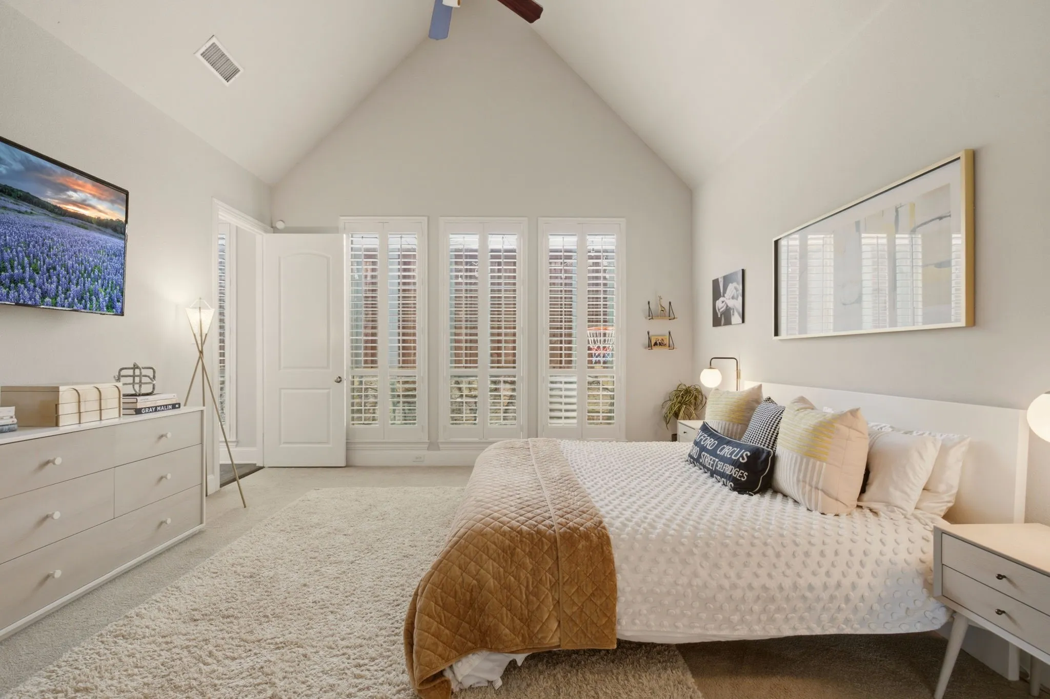 A light-filled spaciousness for a superbly comfortable primary suite. Plush carpet & pad on the floor adds to the softness of the neutral color tones in this home.