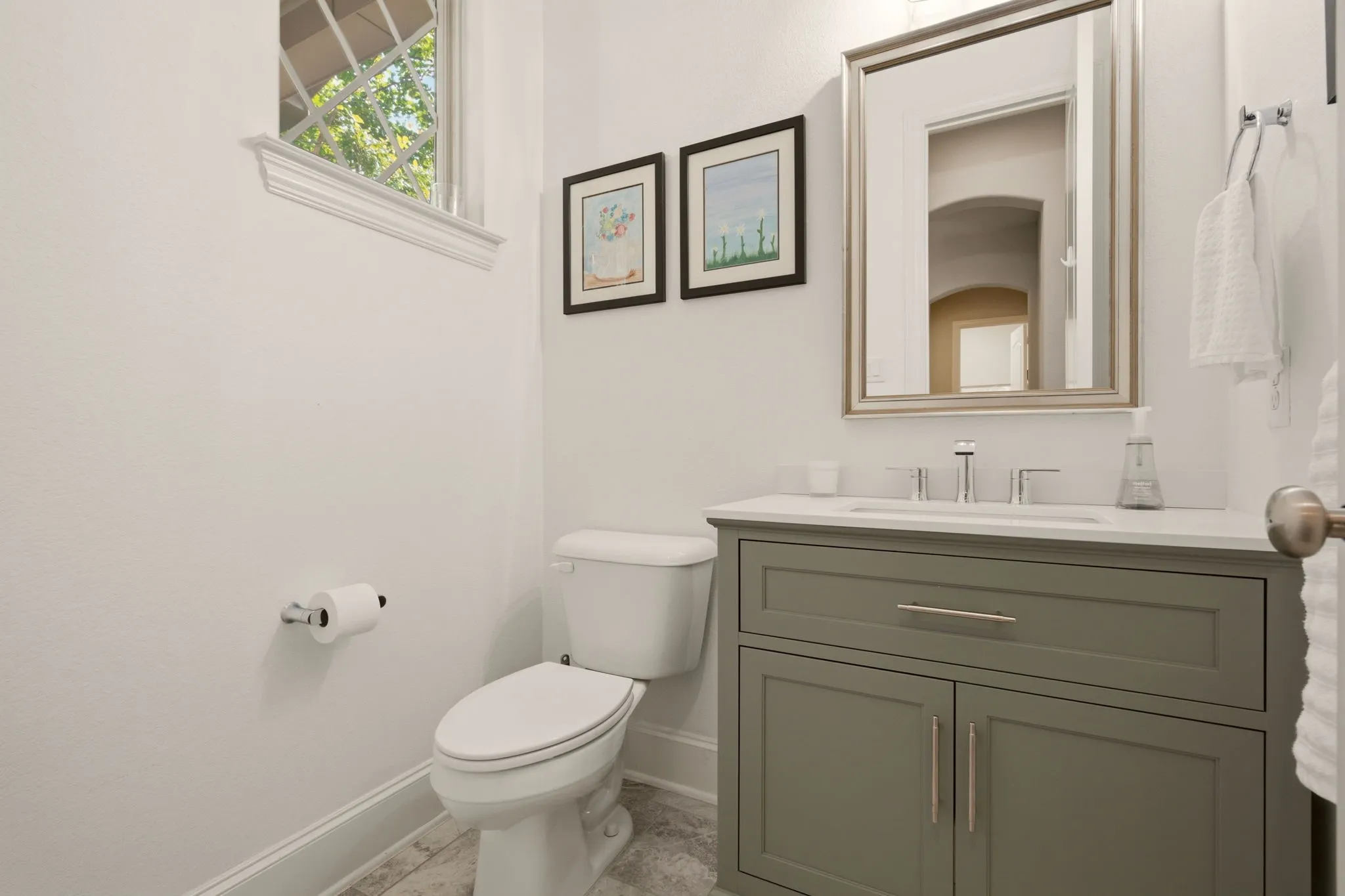 Pristine like the other 3 full baths, this powder bath has a newly installed vanity.