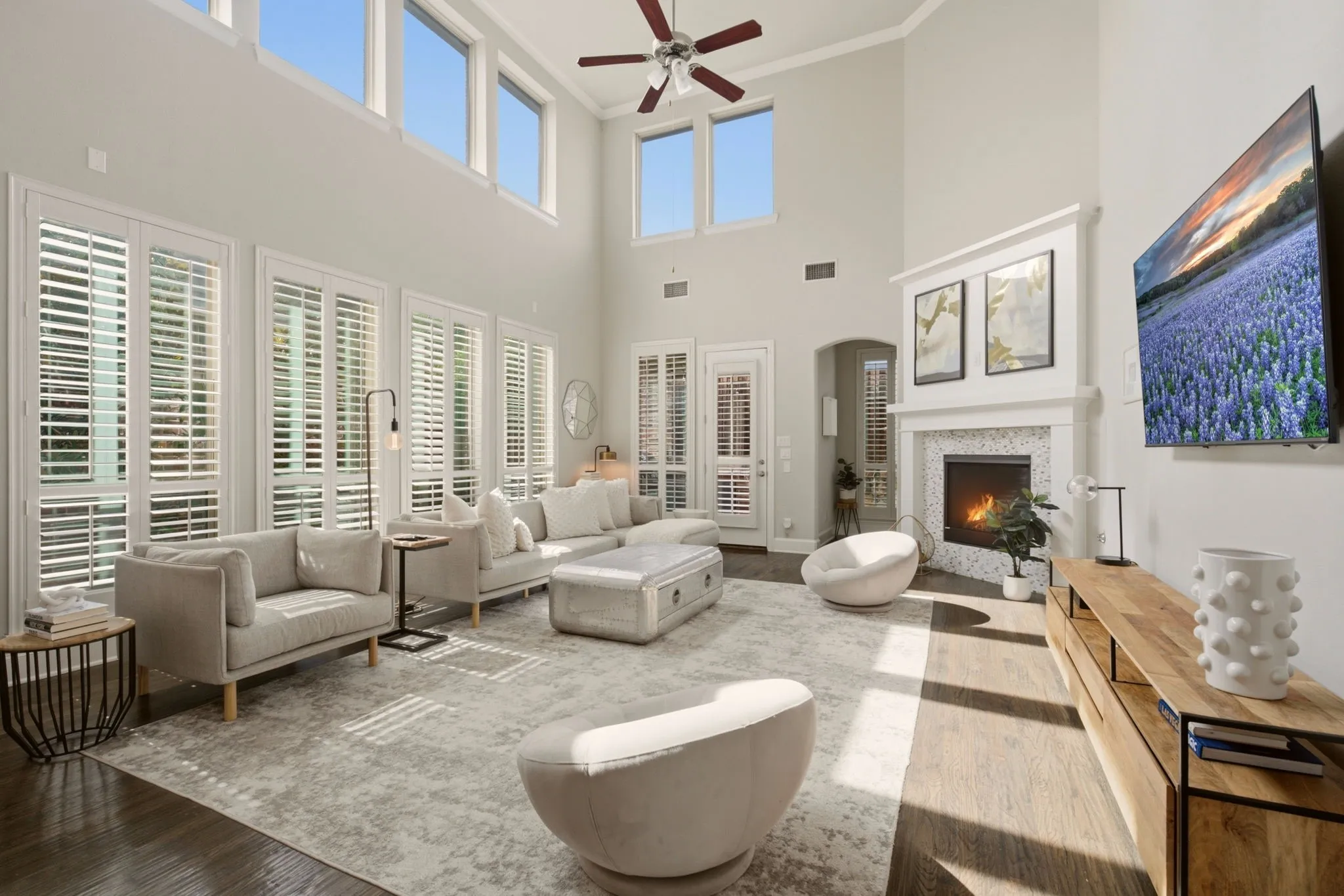 The corner fireplace serves as the room's focal point, adding warmth & architectural interest while achoring the expansive space. A living room large enough for multiple furniture pieces & placement options for your favorite pieces.