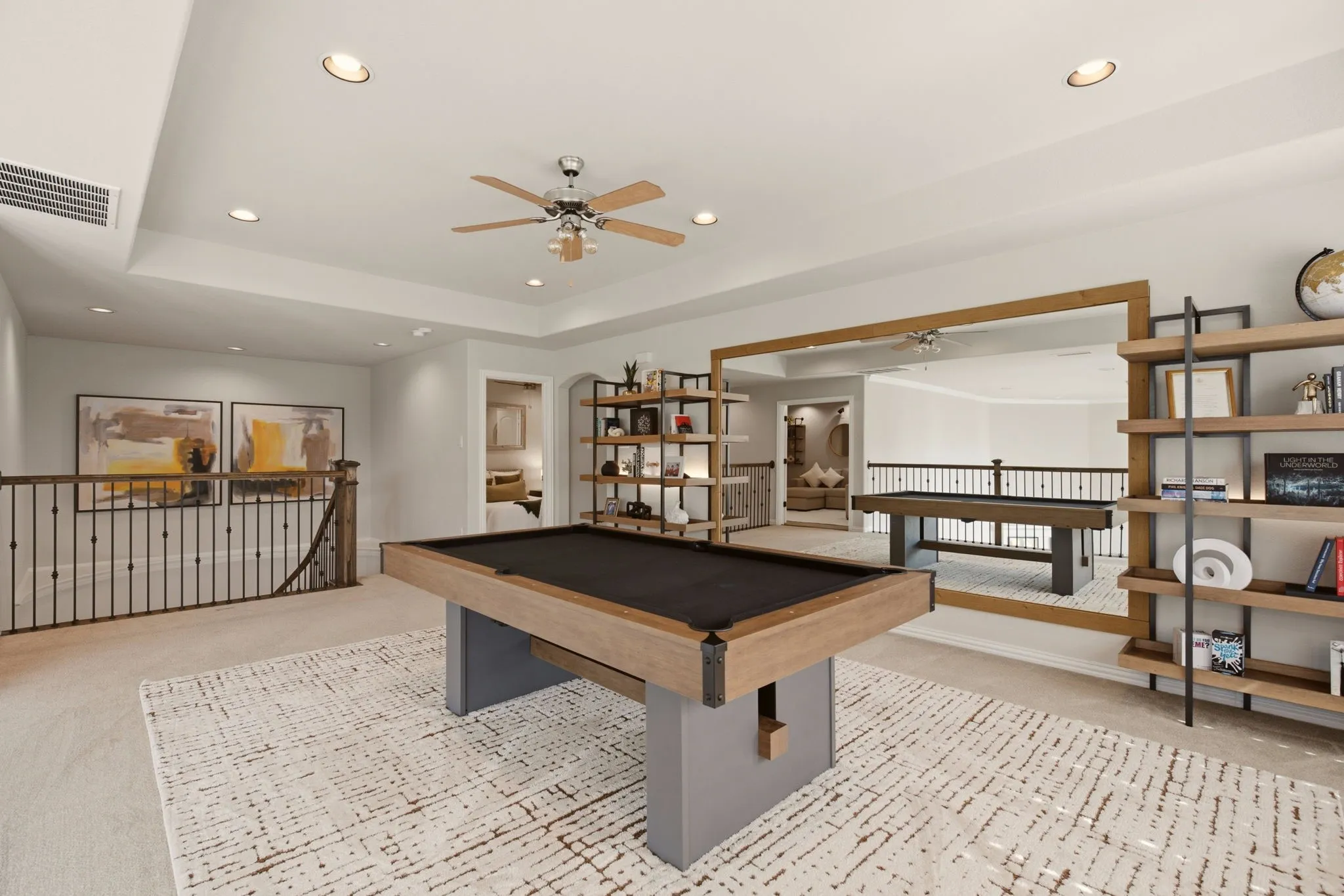 A standout feature of the gameroom is the framed wall mirror, which dramatically expands the visual footprint of the space. It brilliantly catches & reflects the ambient light, creating a bright, energetic environment that feels twice as large. Attached shelving negotiable to remain based on the offer.
