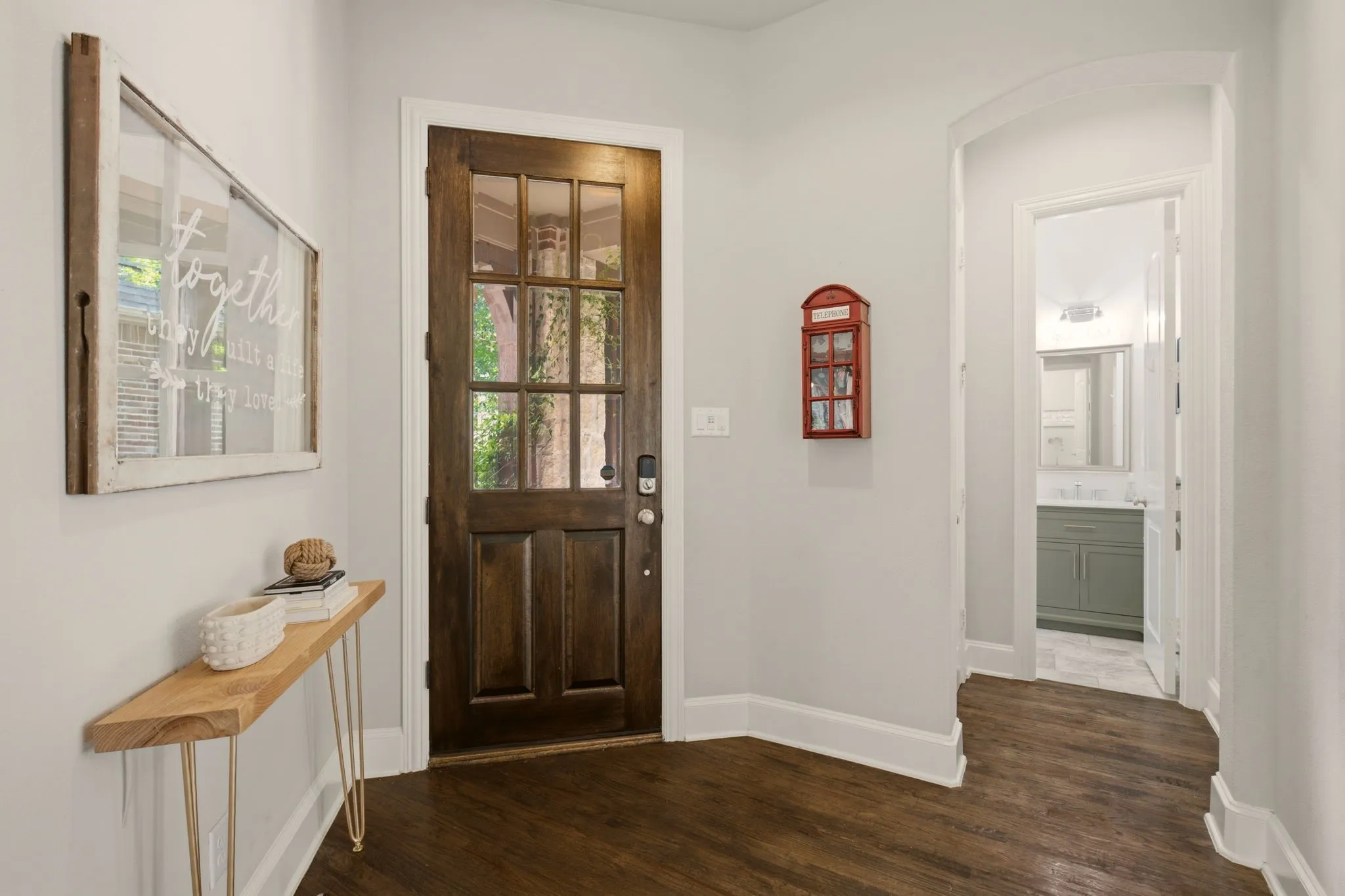 The foyer presents a gracious welcome before opening to the home's expansive living spaces. Rich hardwood floors throughout the first floor + an updated powder bath for guest use.