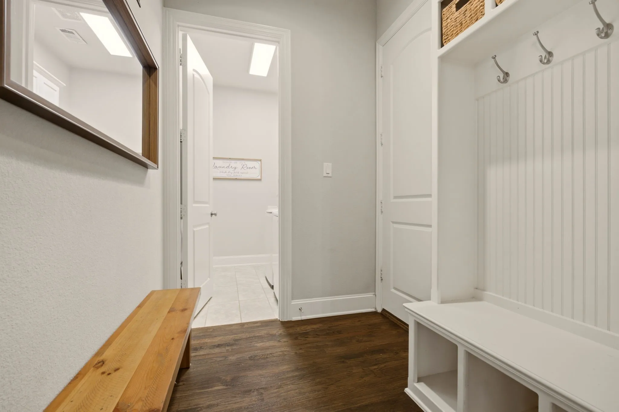Just off the garage entry...a handy mudroom is a dedicated "drop zone" for backbacks, jackets, daily clutter...while keeping the rest of your home clean &org anized.