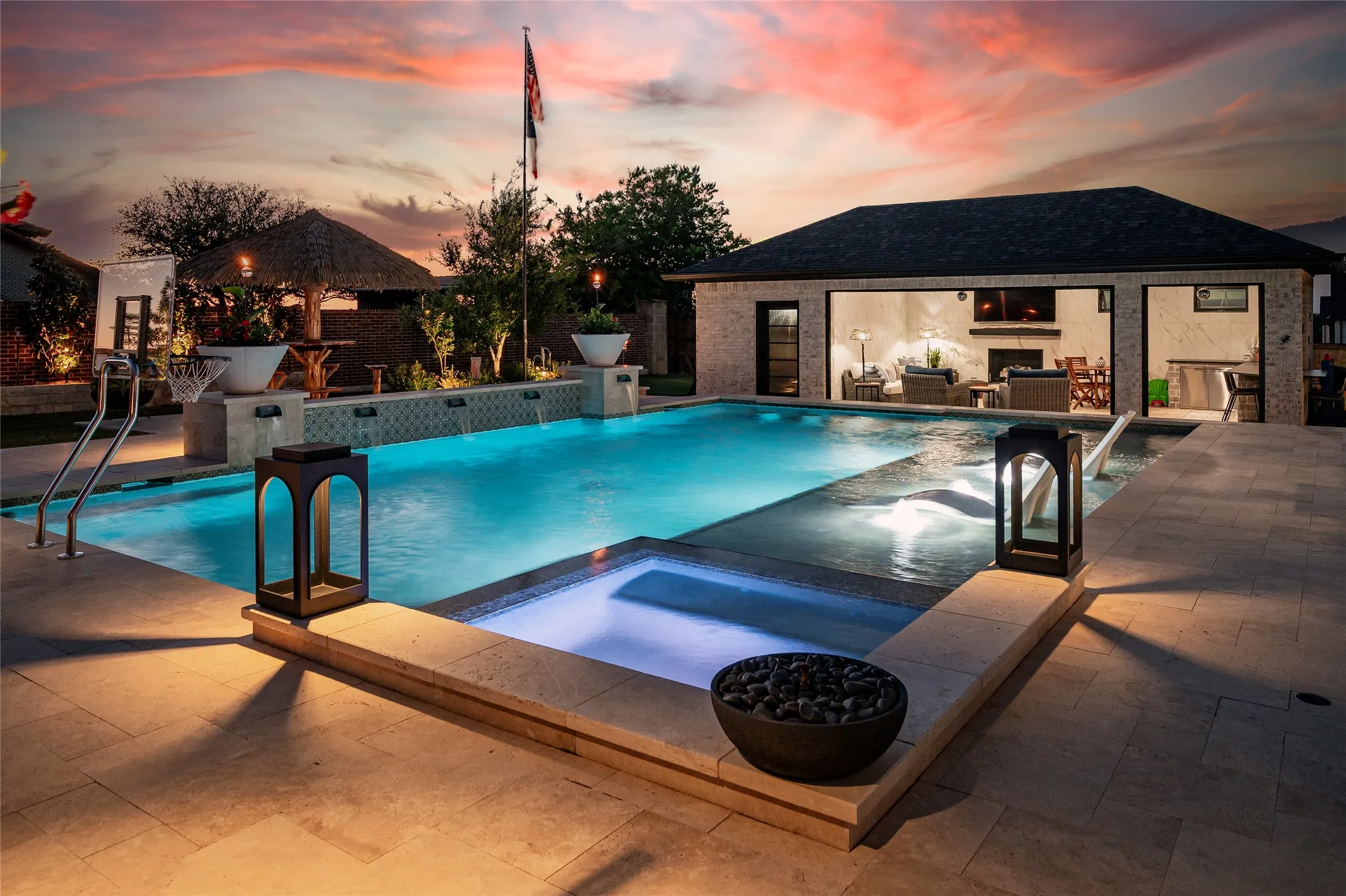 Stunning sunset photo, fantastic pool house at one end of the pool and yard. Entertaining paradise!