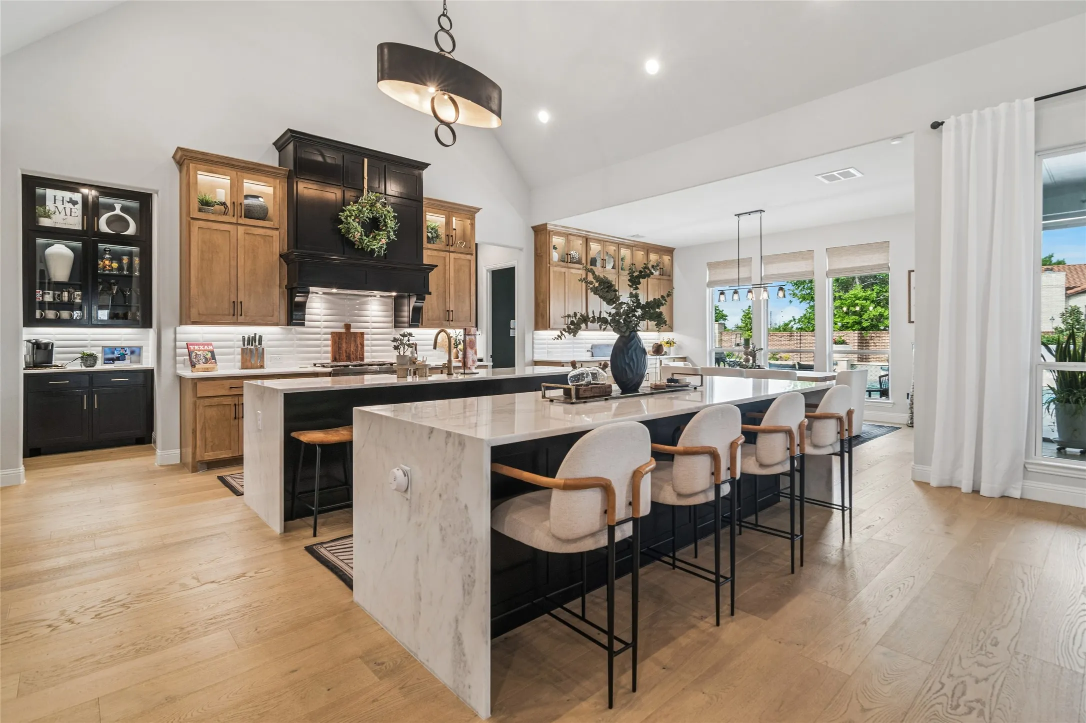 2 butlers pantries, 2 pantries, custom painted hood with vent, tiled backsplash. Stained and painted cabinetry, glassed cabinets for display with lighting. Lots of counter top space for preparing food and entertaining.