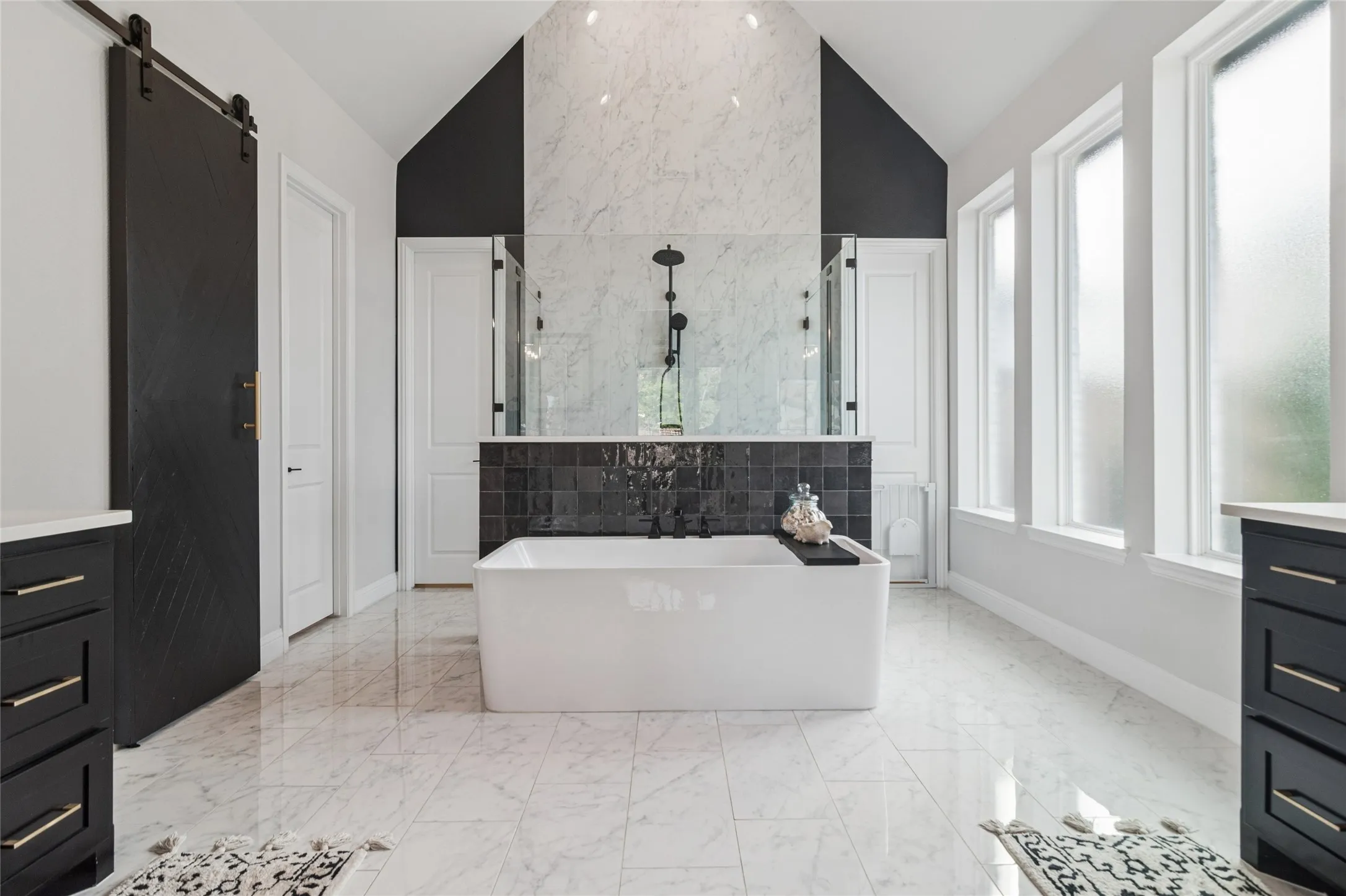 Oversized soaking tub, dual shower doors to enter large walk in shower, 24x12 tile flow from the floor up the entire wall of the shower. 2 large walk in closets, linen closet.