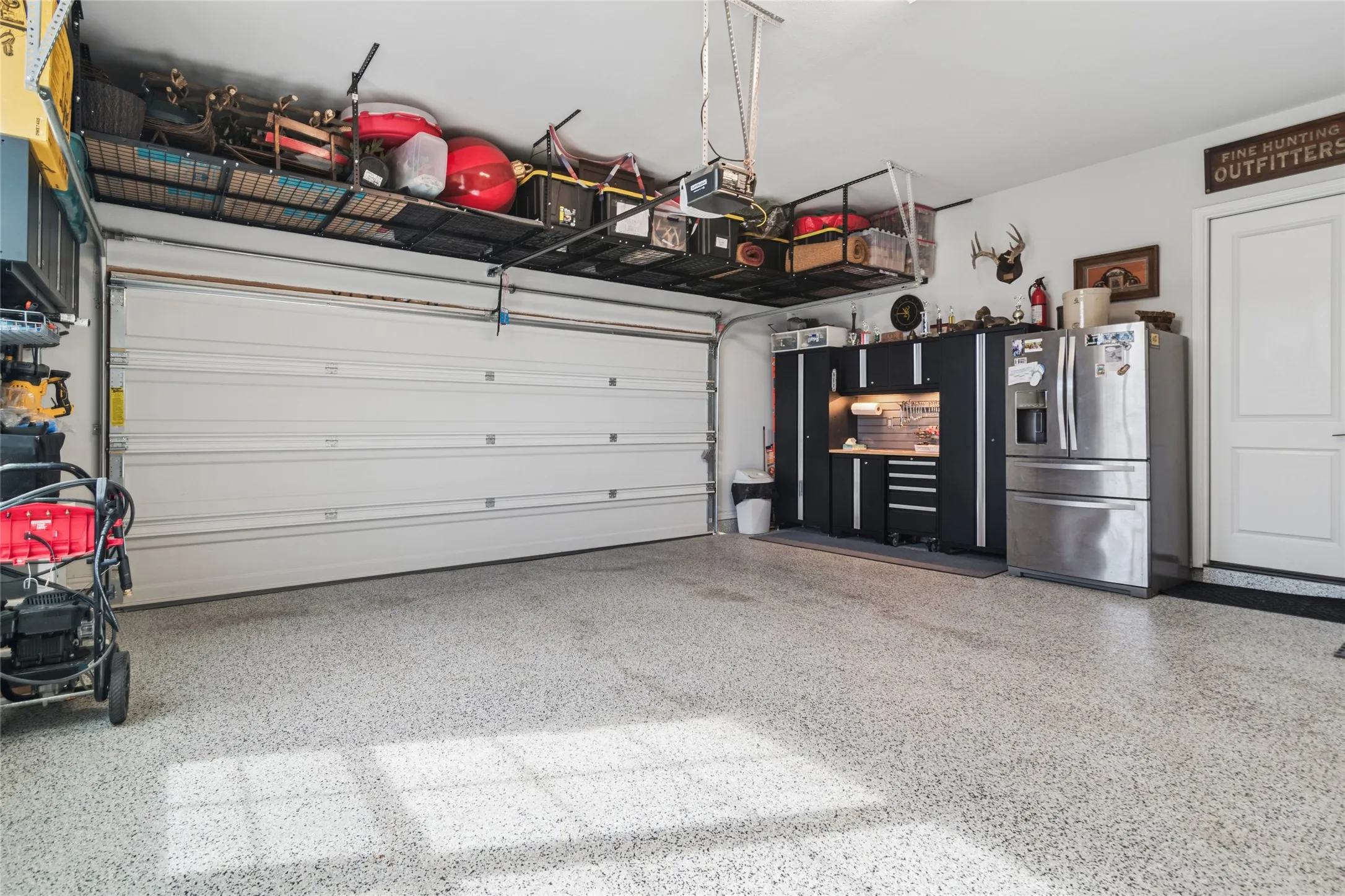 One of 2 garages, this one has 1 double door, the second garage has 2 single doors. Epoxy flooring, loads of storage, oversized.