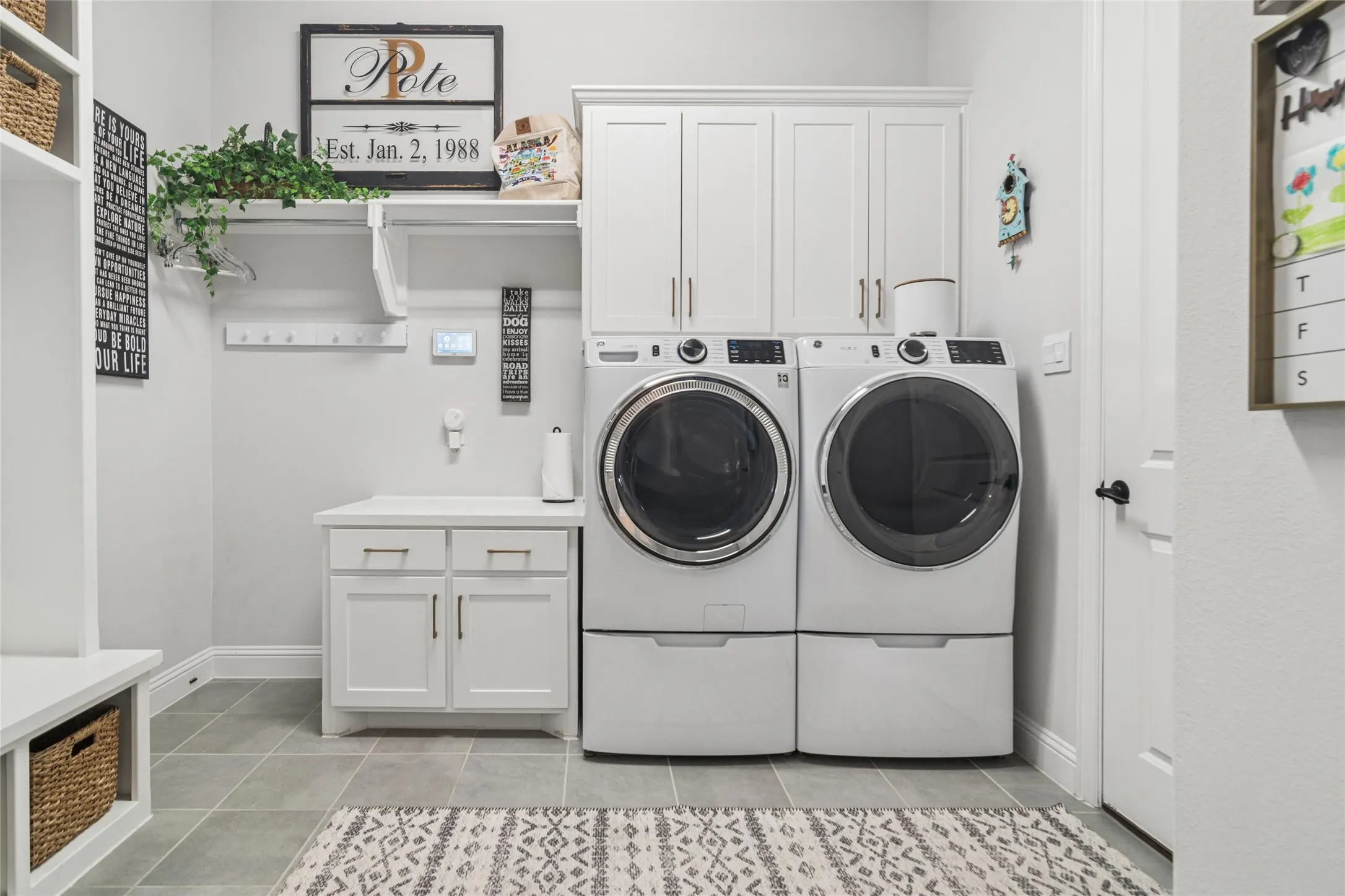 Large laundry room offers hanging for clothing, built in cabinets, folding table, cubbies with storage above and below. Door to 2nd 2 car garage for ease of unloading groceries.