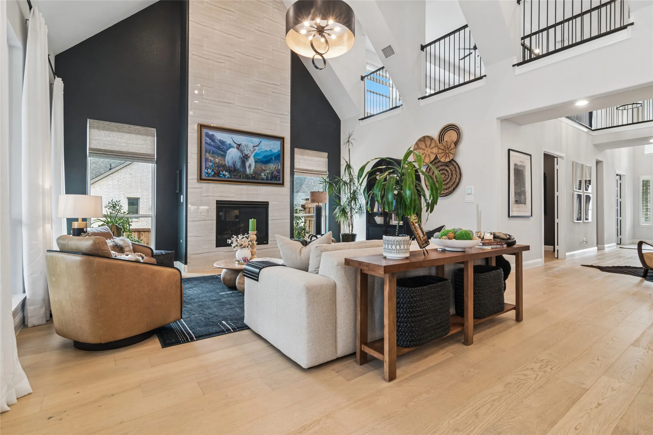 Main living area with floor to ceiling tiled fireplace, with painted walls on either side to add character, dramatic soaring ceiling with center beam.
