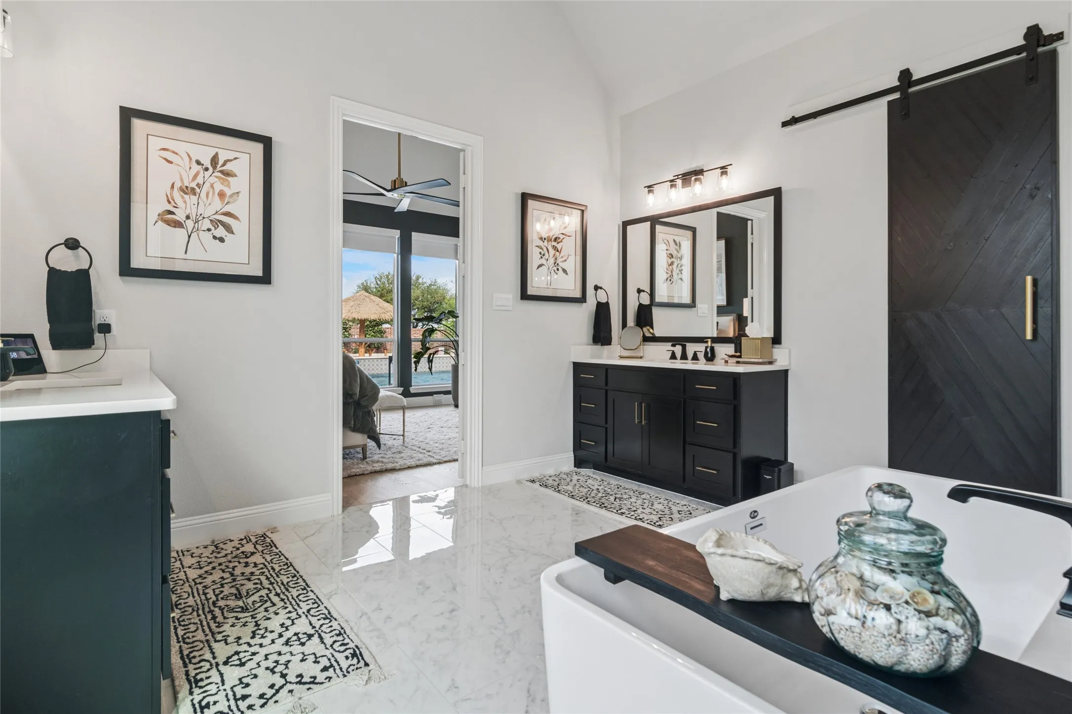 Dual vanities, lots of natural light fill this oversized bathroom.