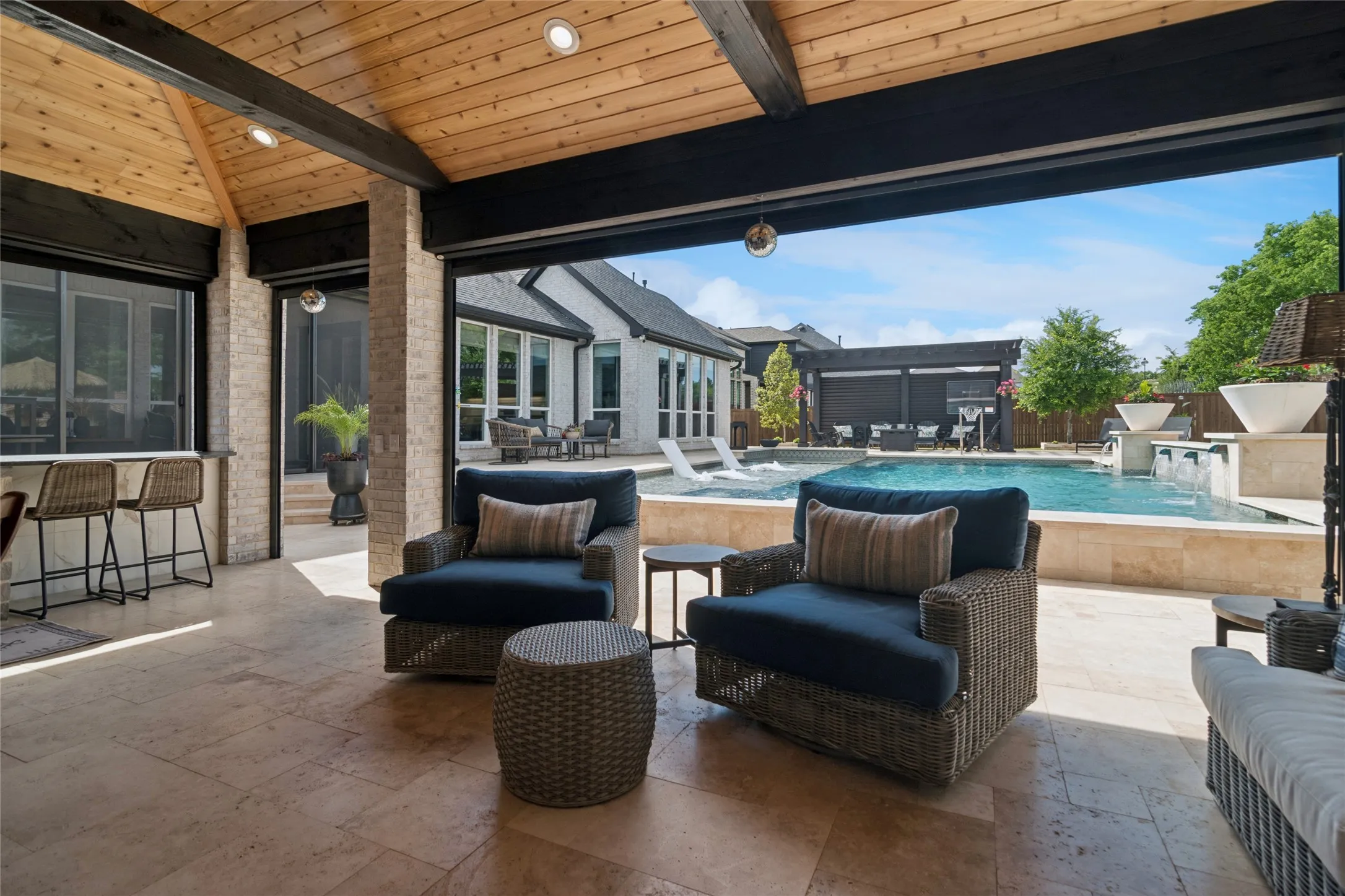Looking out from the pool house. Electric screens enclose the pool house.