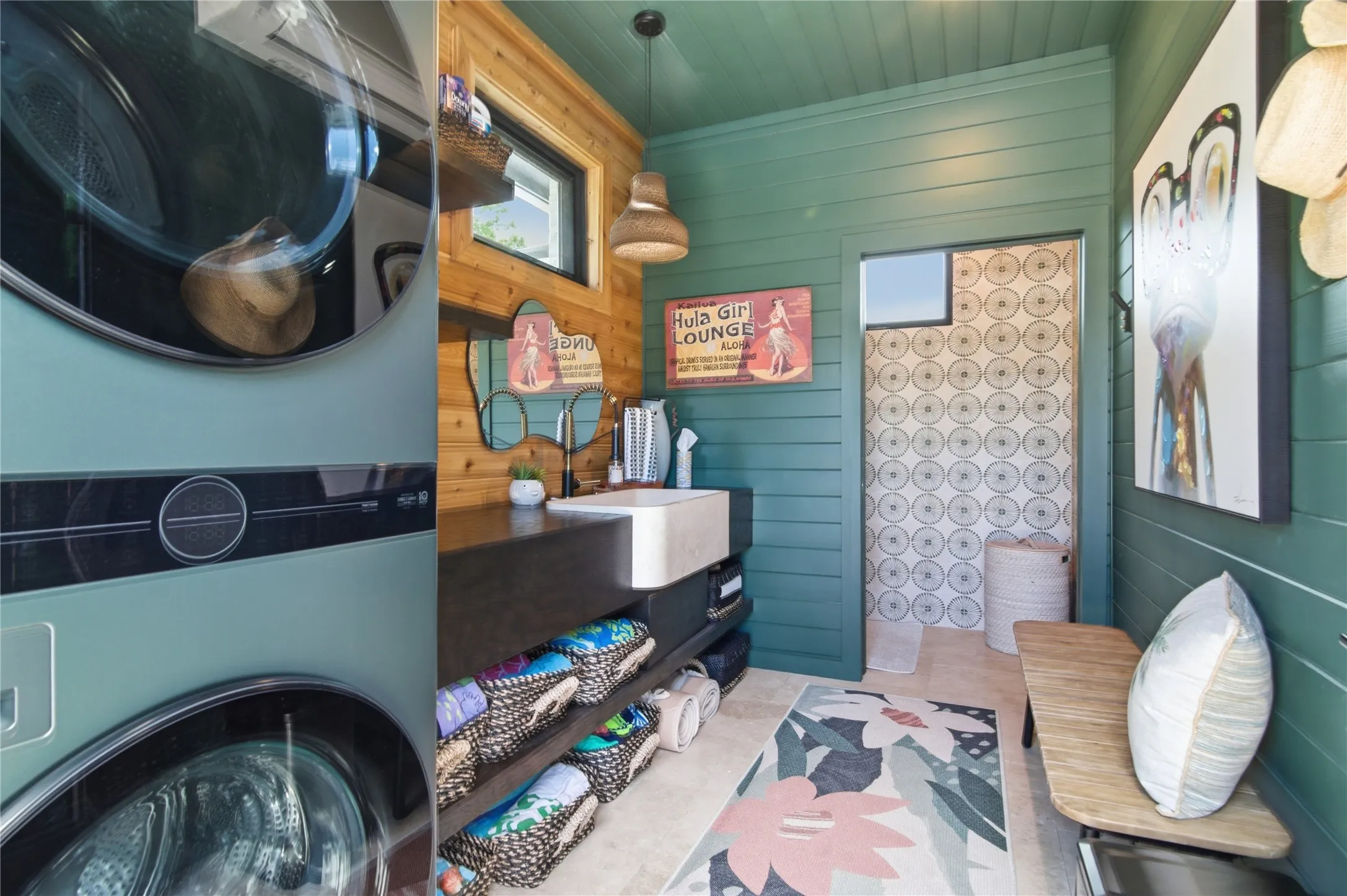 Beautiful pool bath, room for stackable washer and dryer, apron front oversized sink, counter space with storage below, toilet area with custom tile, shiplap walls, transom windows for light into bathroom. Iron with privacy glass door into the bathroom.