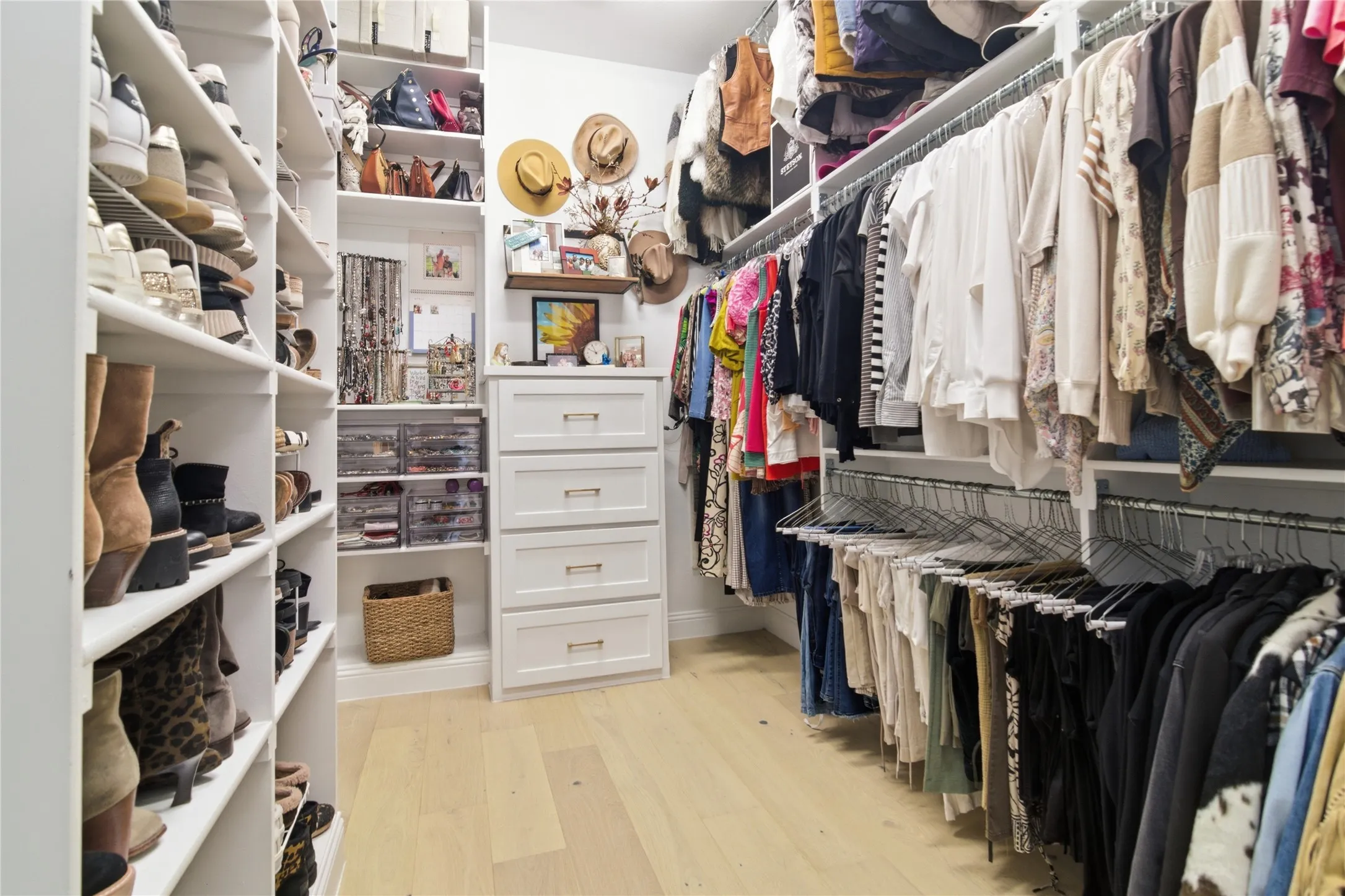 One of 2 primary closets, oversized, built in dressers, this closet has direct access into the laundry room.